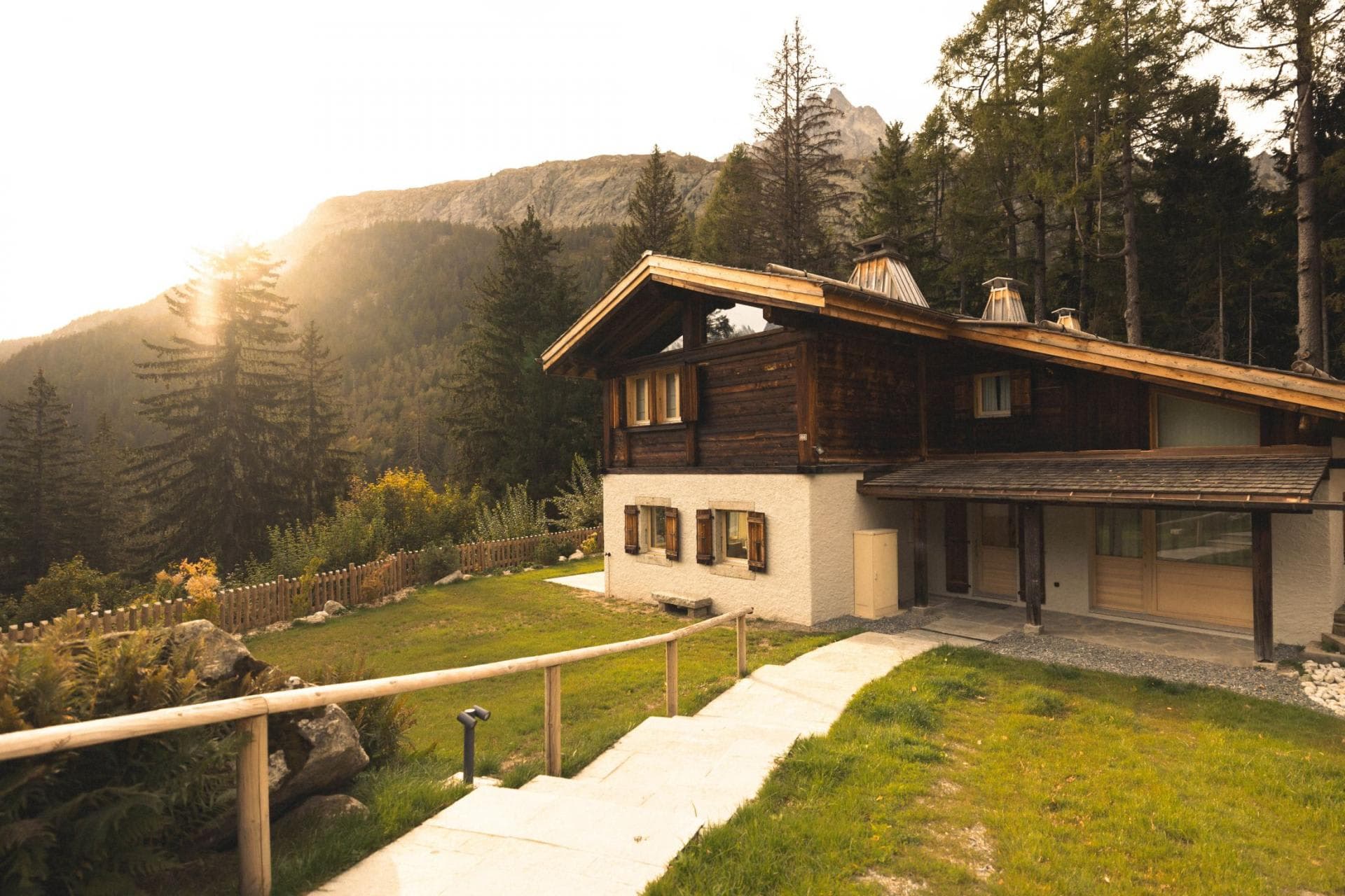 Chalet exterior with mountain views and private lawn area
