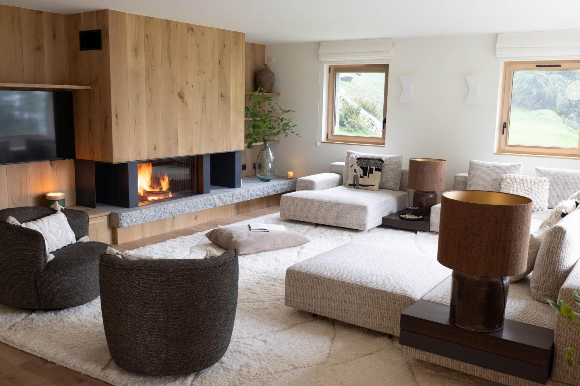Living area with wood-burning fireplace and modular lounge seating