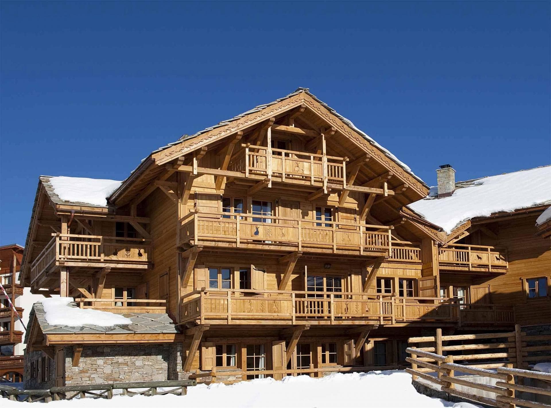 Timber chalet exterior with private balconies for every floor