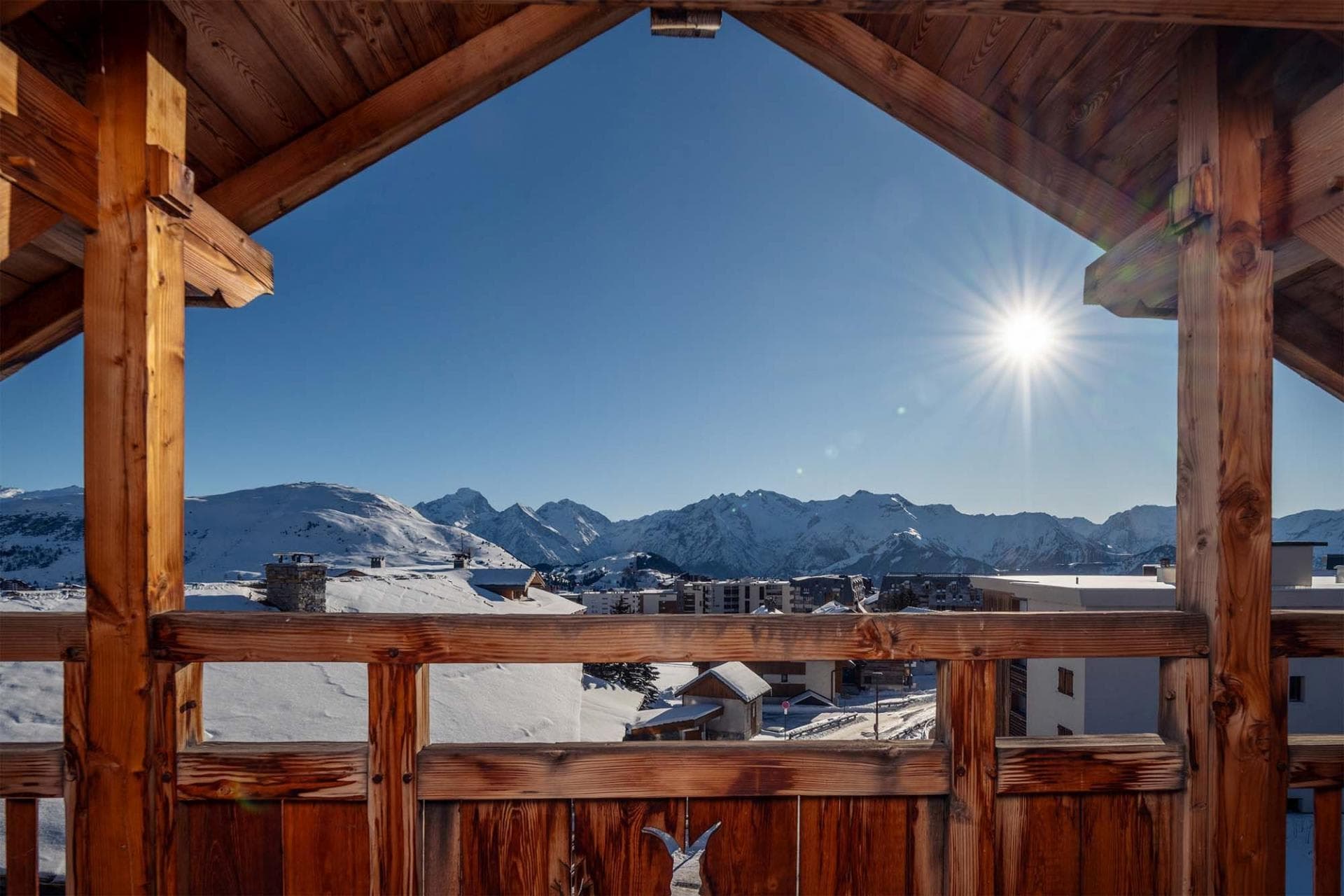 Covered timber balcony with panoramic mountain and village views