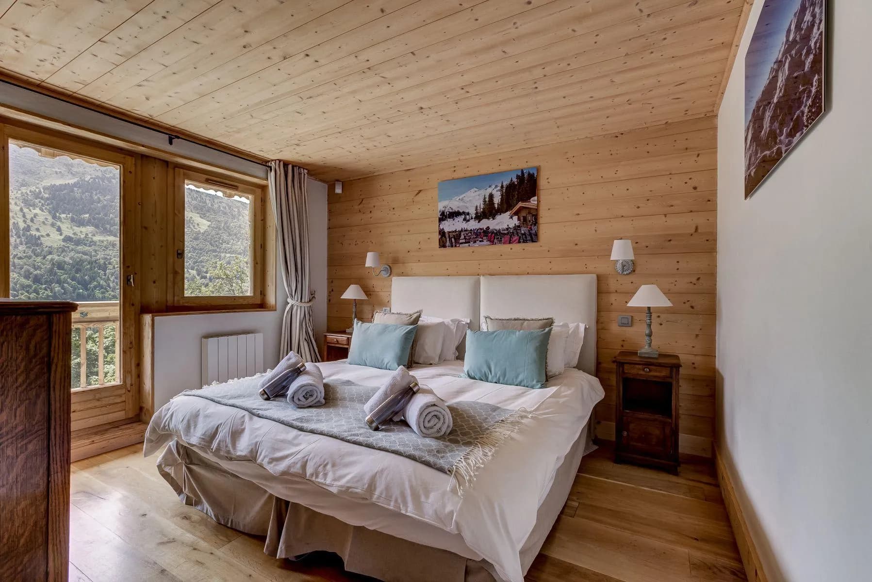 Double bedroom with timber walls and balcony doors