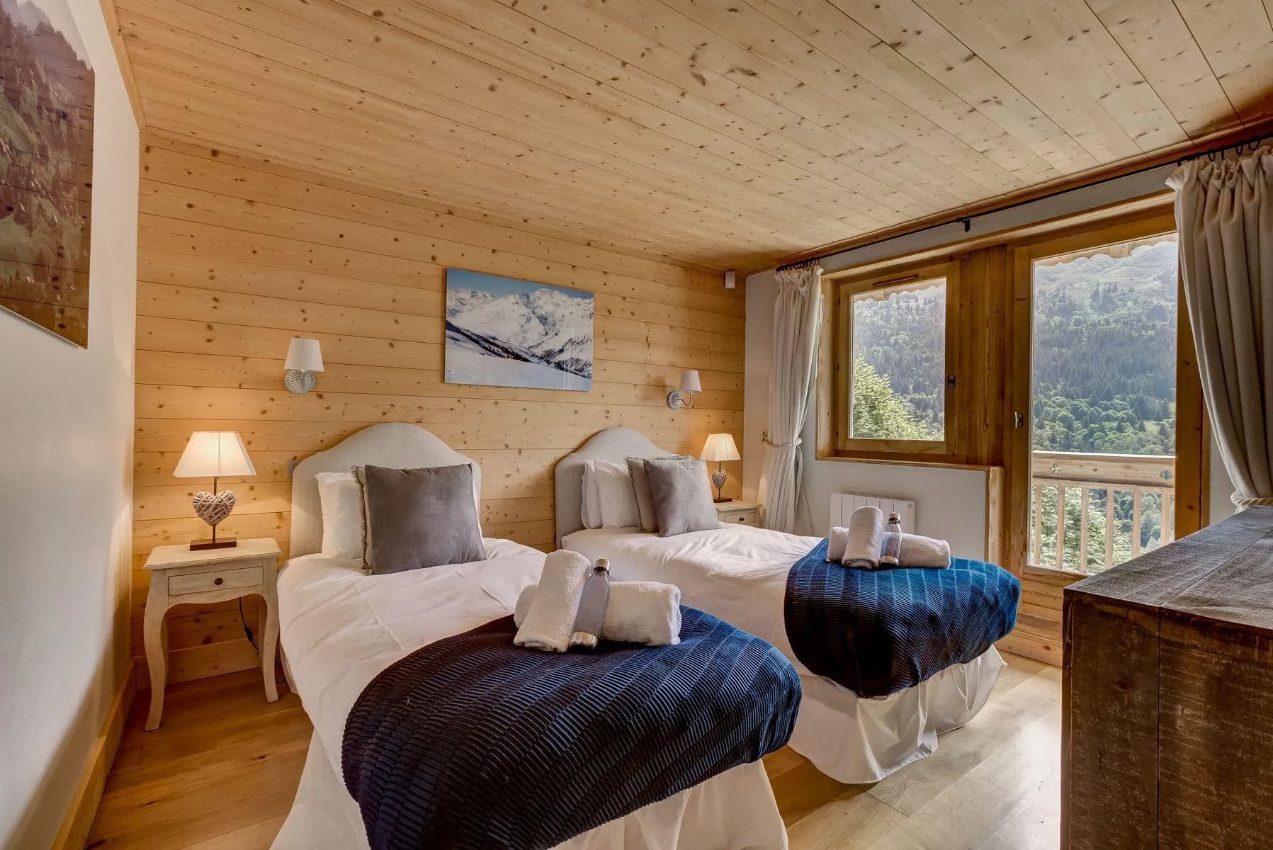 Twin bedroom with timber walls and mountain views