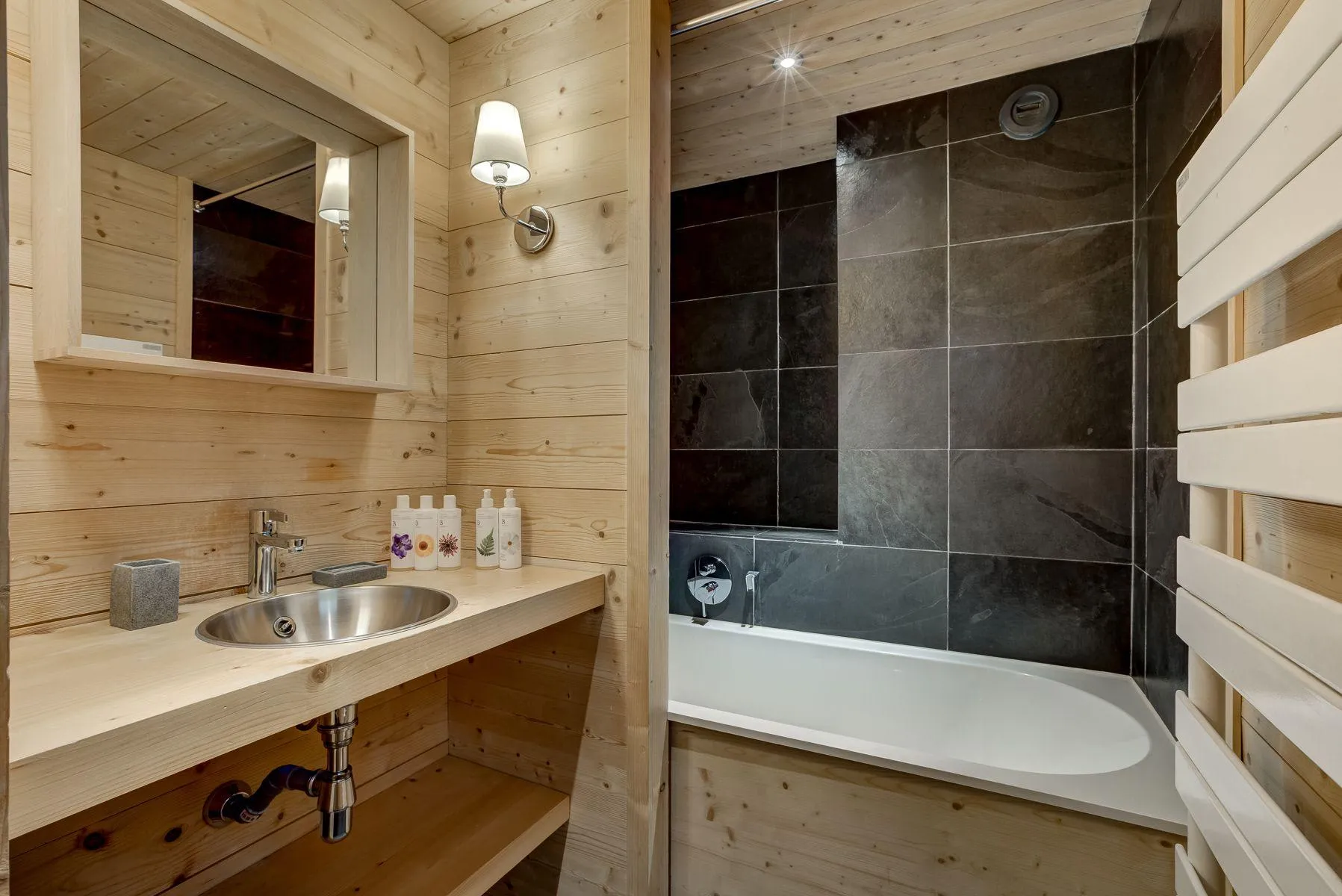 Timber bathroom with a bath, shower, basin and heated towel rail