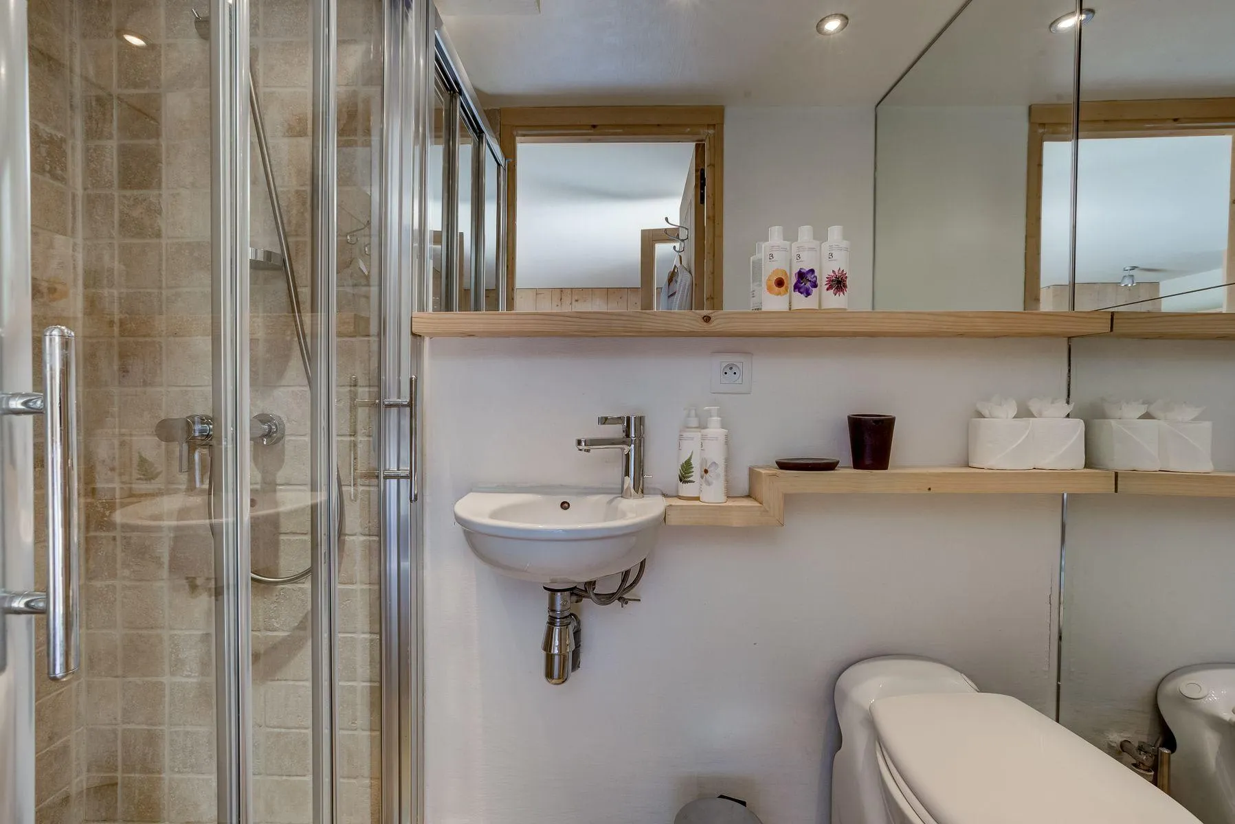 En-suite bathroom with a basin, walk-in shower and timber shelving