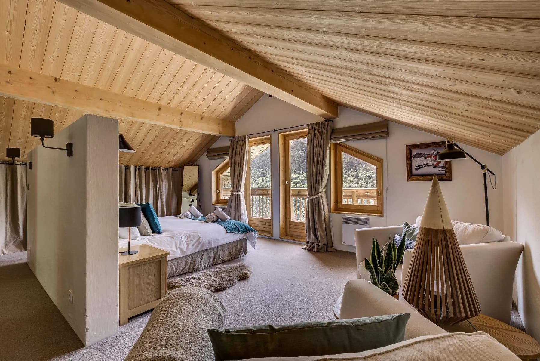 Master suite with a double bed, seating area and balcony doors