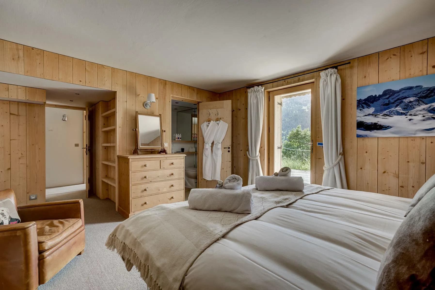 Twin bedroom with timber panelling and balcony doors