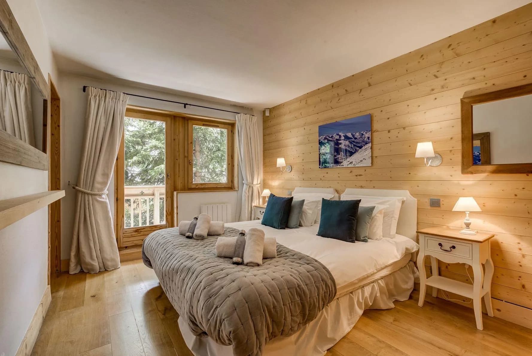 Twin bedroom with mountain artwork and balcony doors