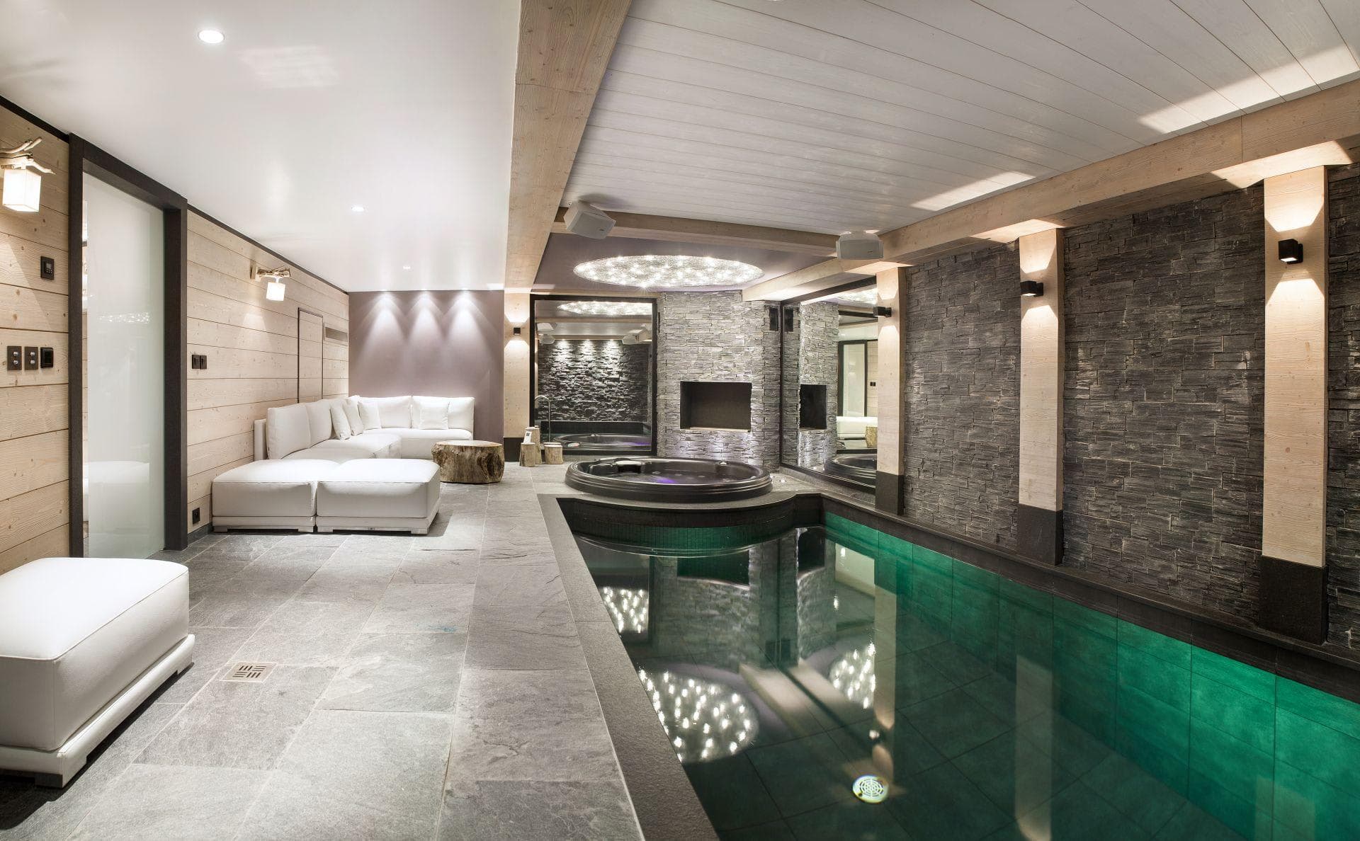 Indoor pool and integrated hot tub with lounge seating area