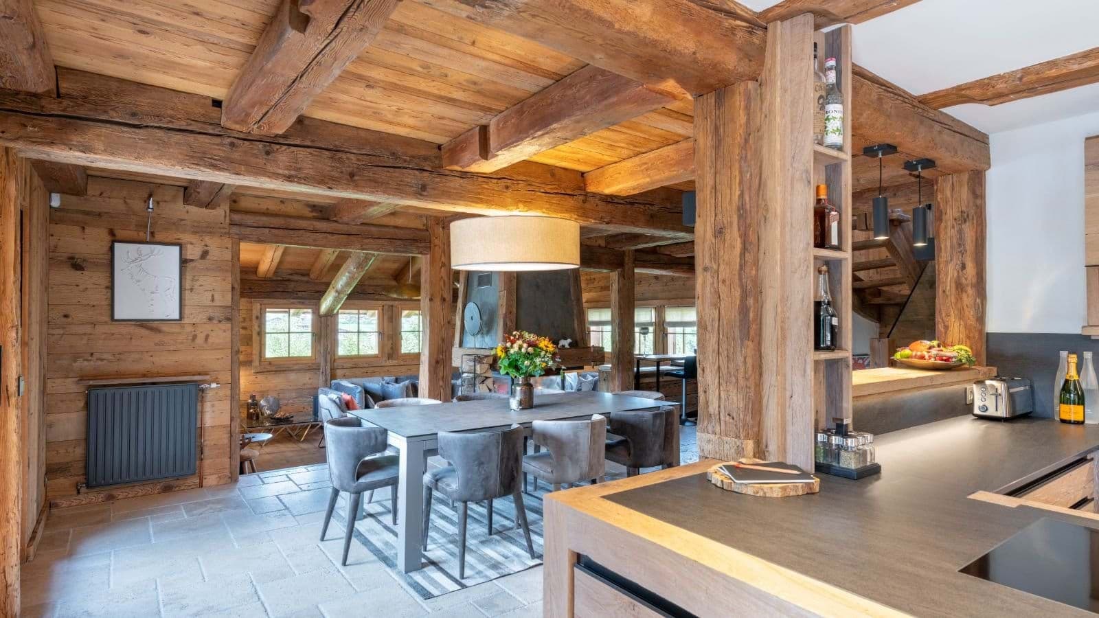 Open-plan dining area and kitchen with original reclaimed timber beams