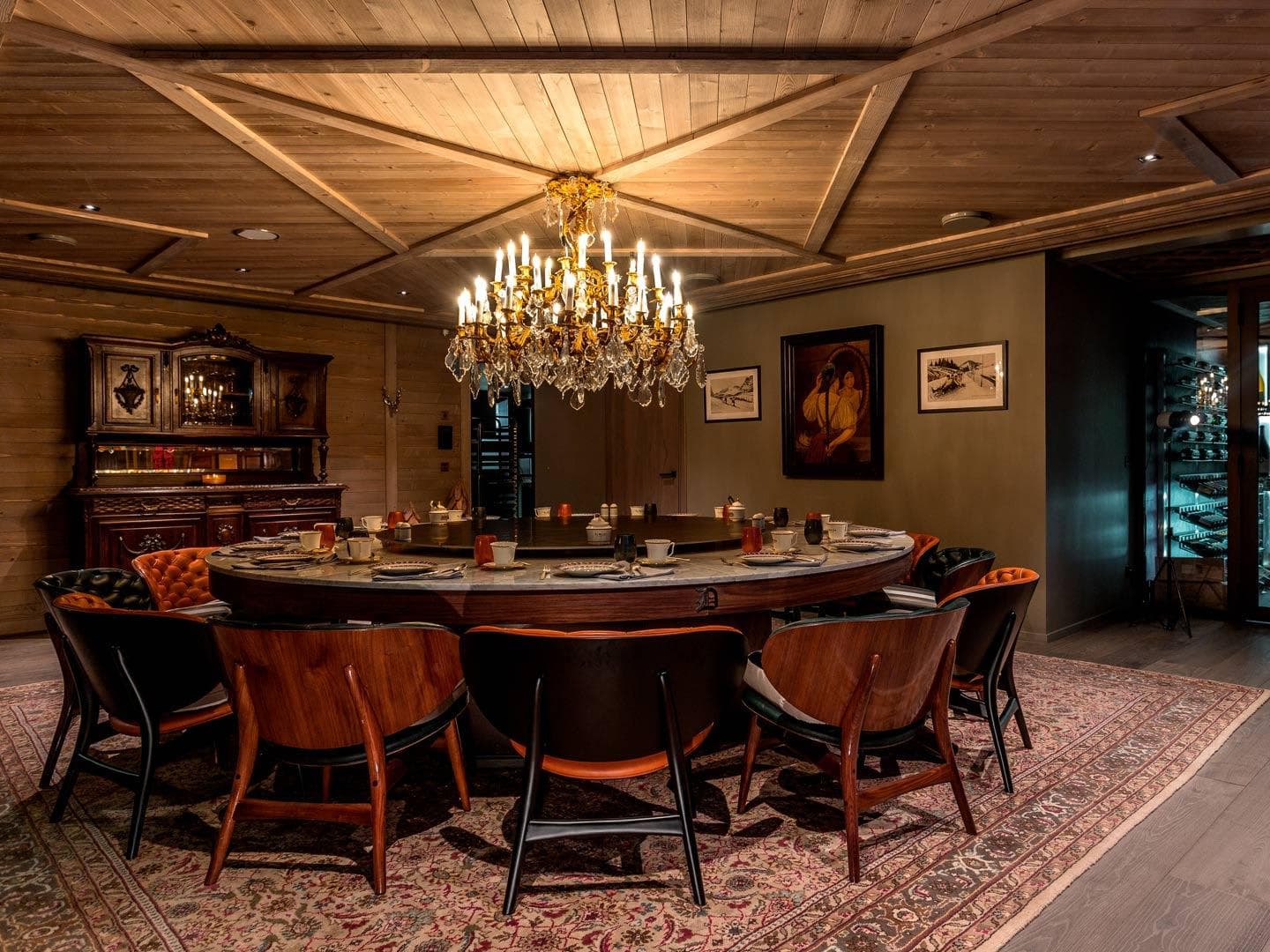 Dining room with circular table seating 12 and integrated wine storage