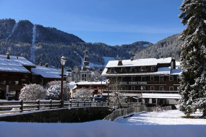 Snowy village view with visible ski runs in the background