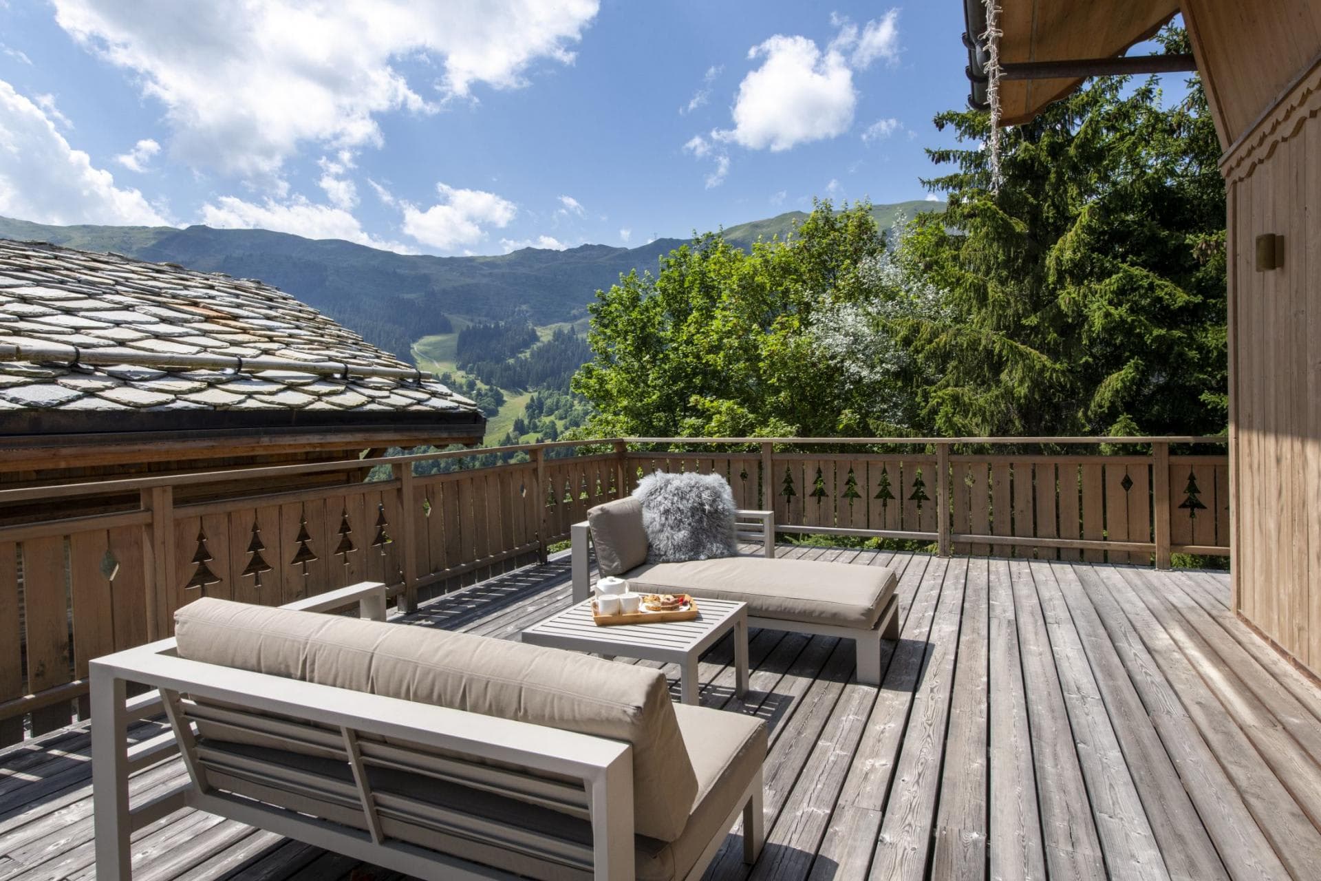 Private sun deck with lounge seating and alpine mountain views