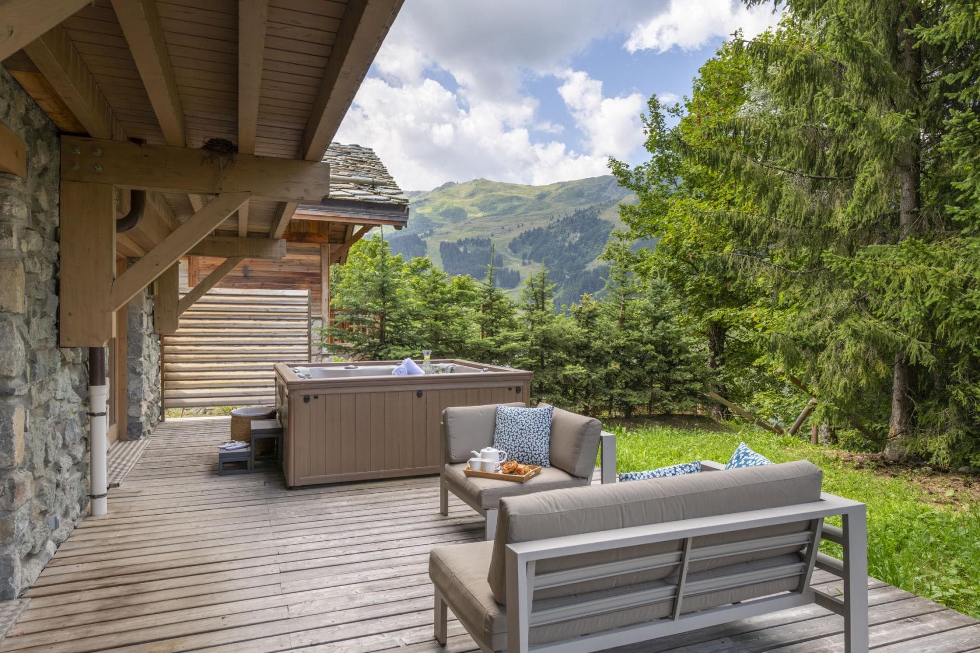 Covered timber deck with hot tub and alpine mountain views