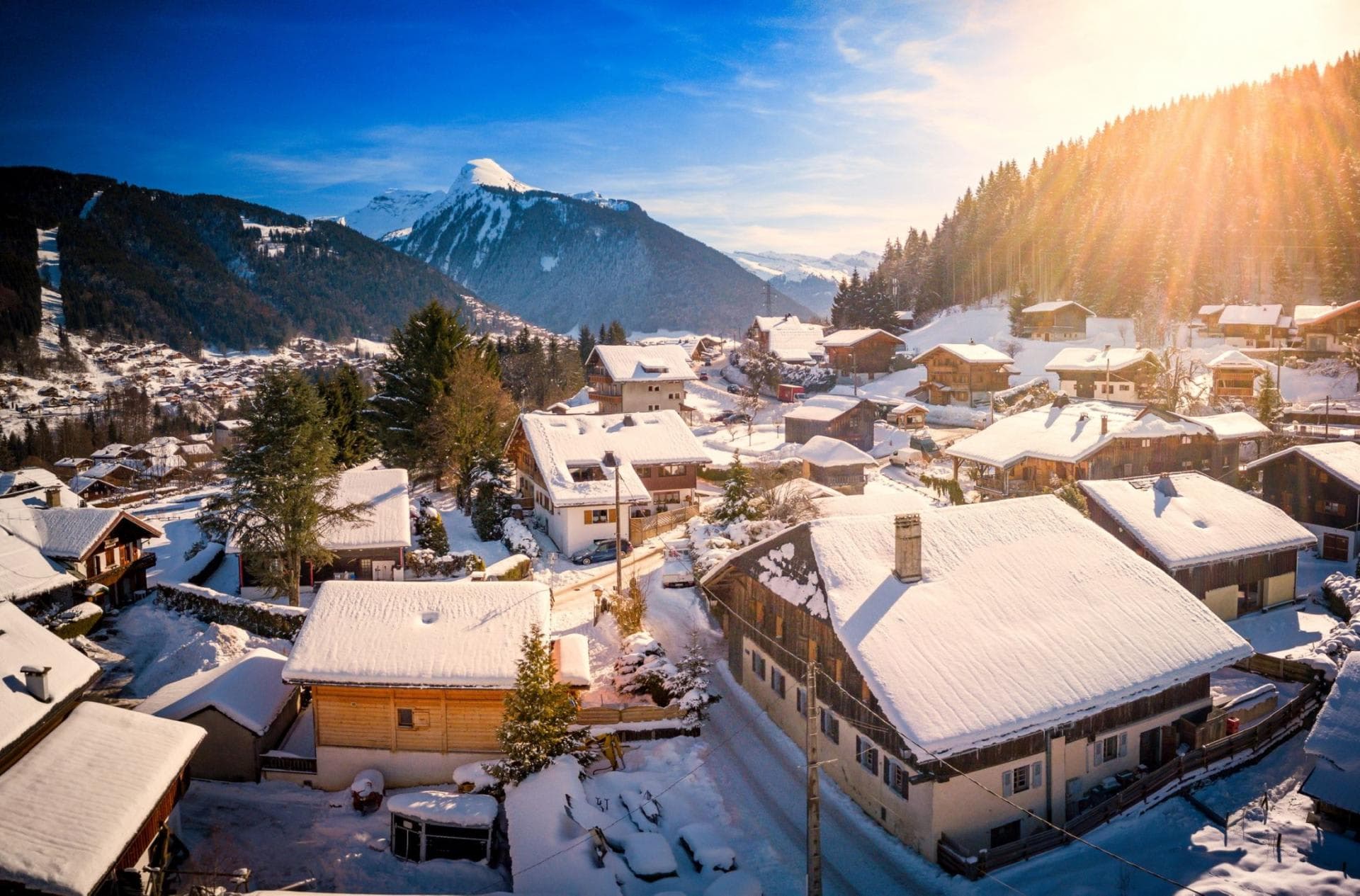 Alpine village view with surrounding snow-capped mountain peaks