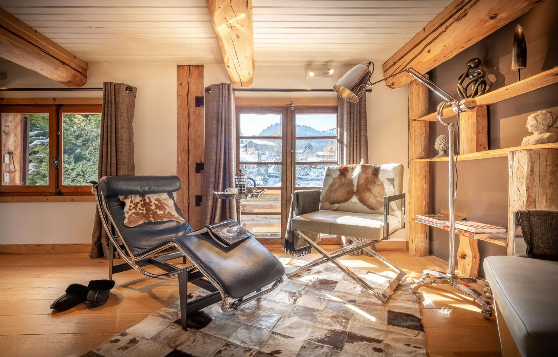 Reading nook with leather chaise lounge and mountain village views