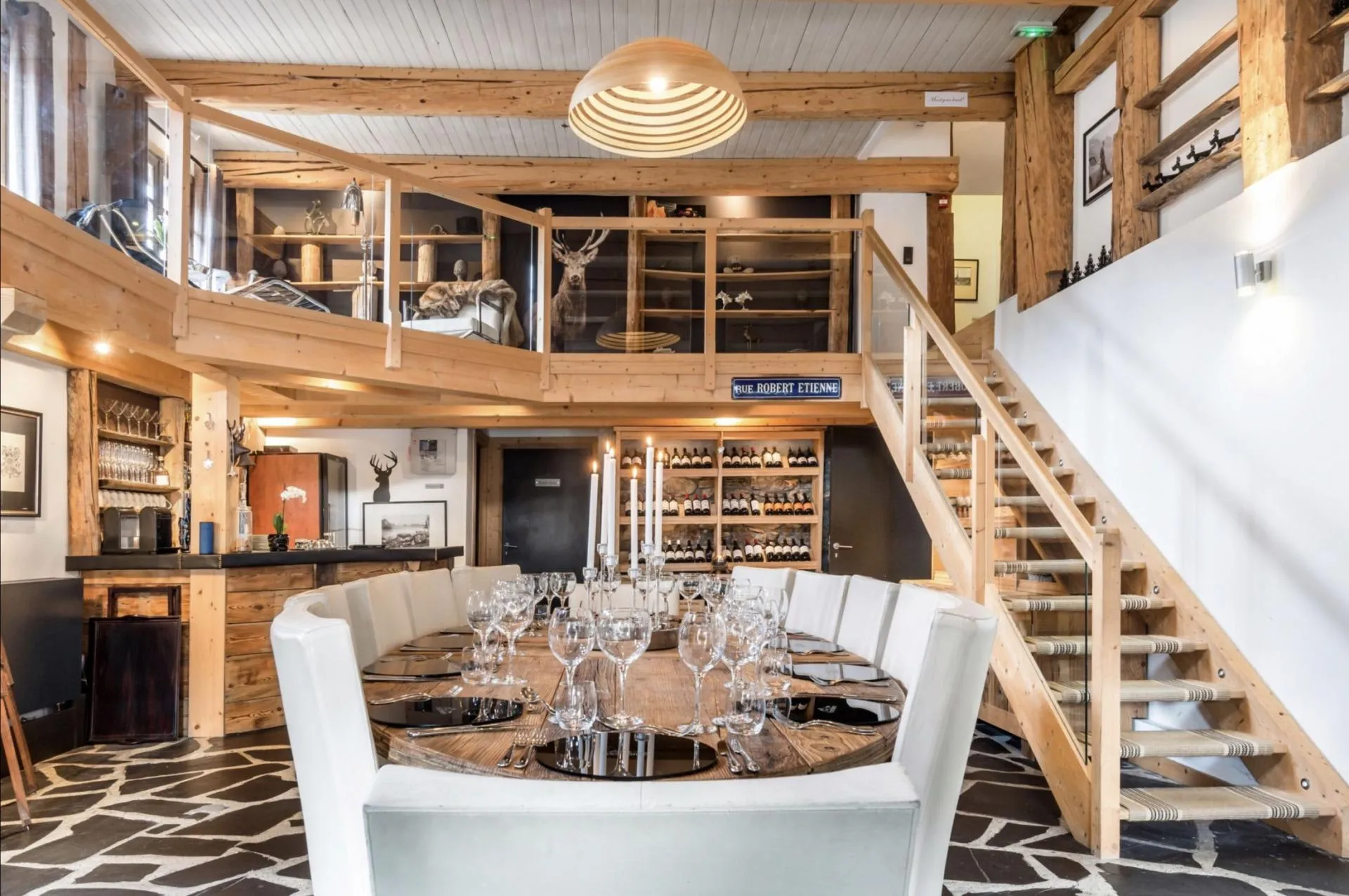 Double-height dining area with timber wine storage and mezzanine