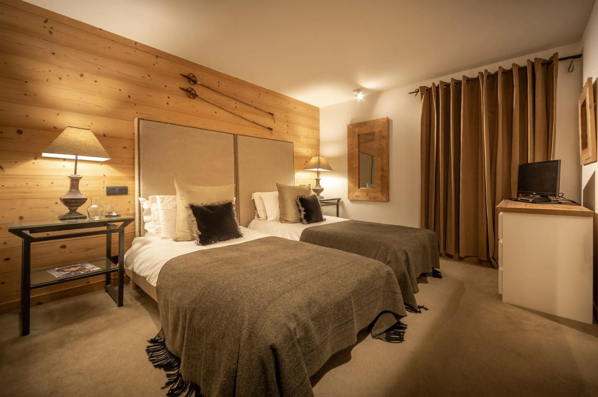 Bedroom with twin beds and timber-panelled walls