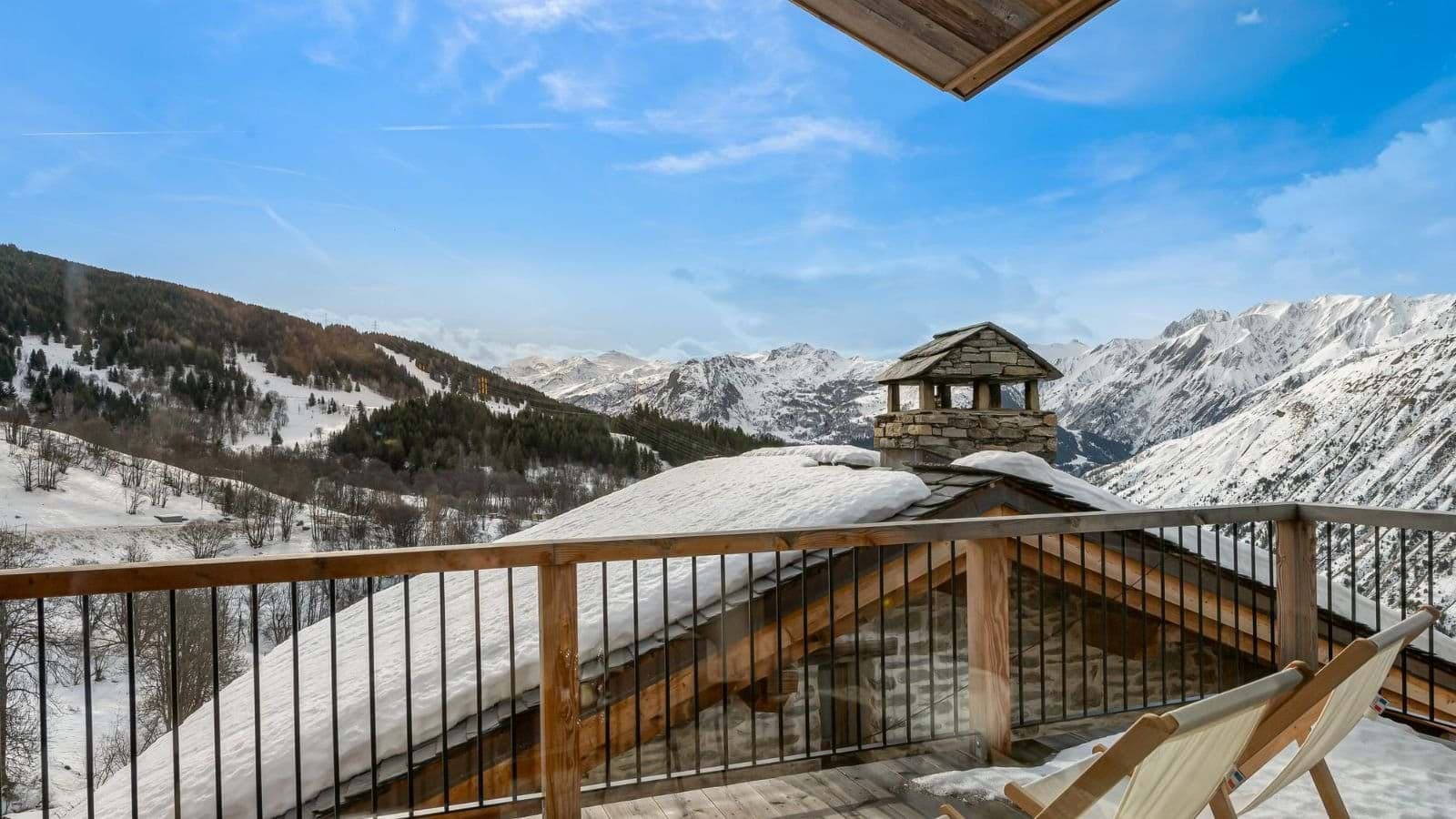 Private balcony with lounge seating and panoramic mountain views