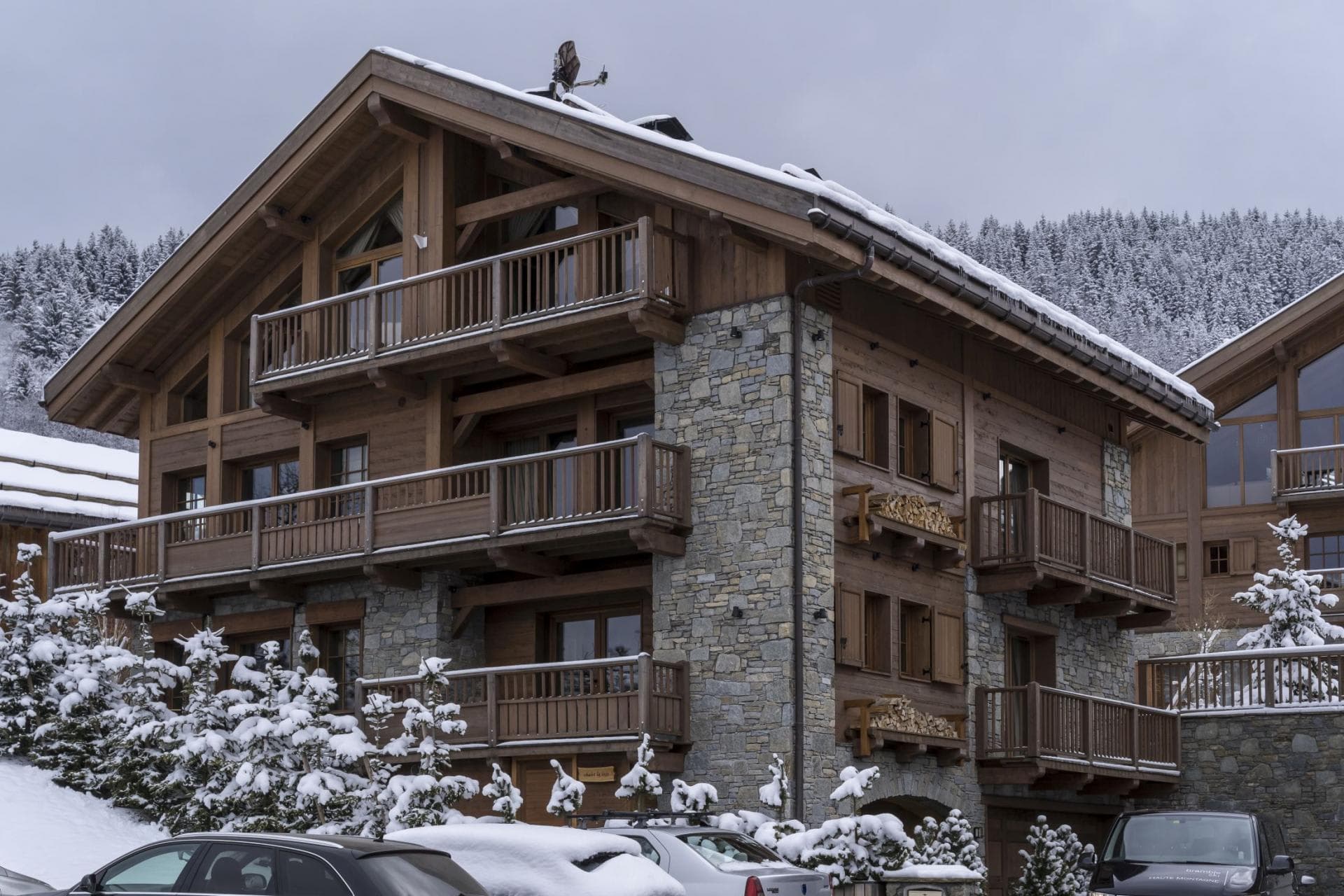 Ski chalet exterior featuring private balconies and driveway parking