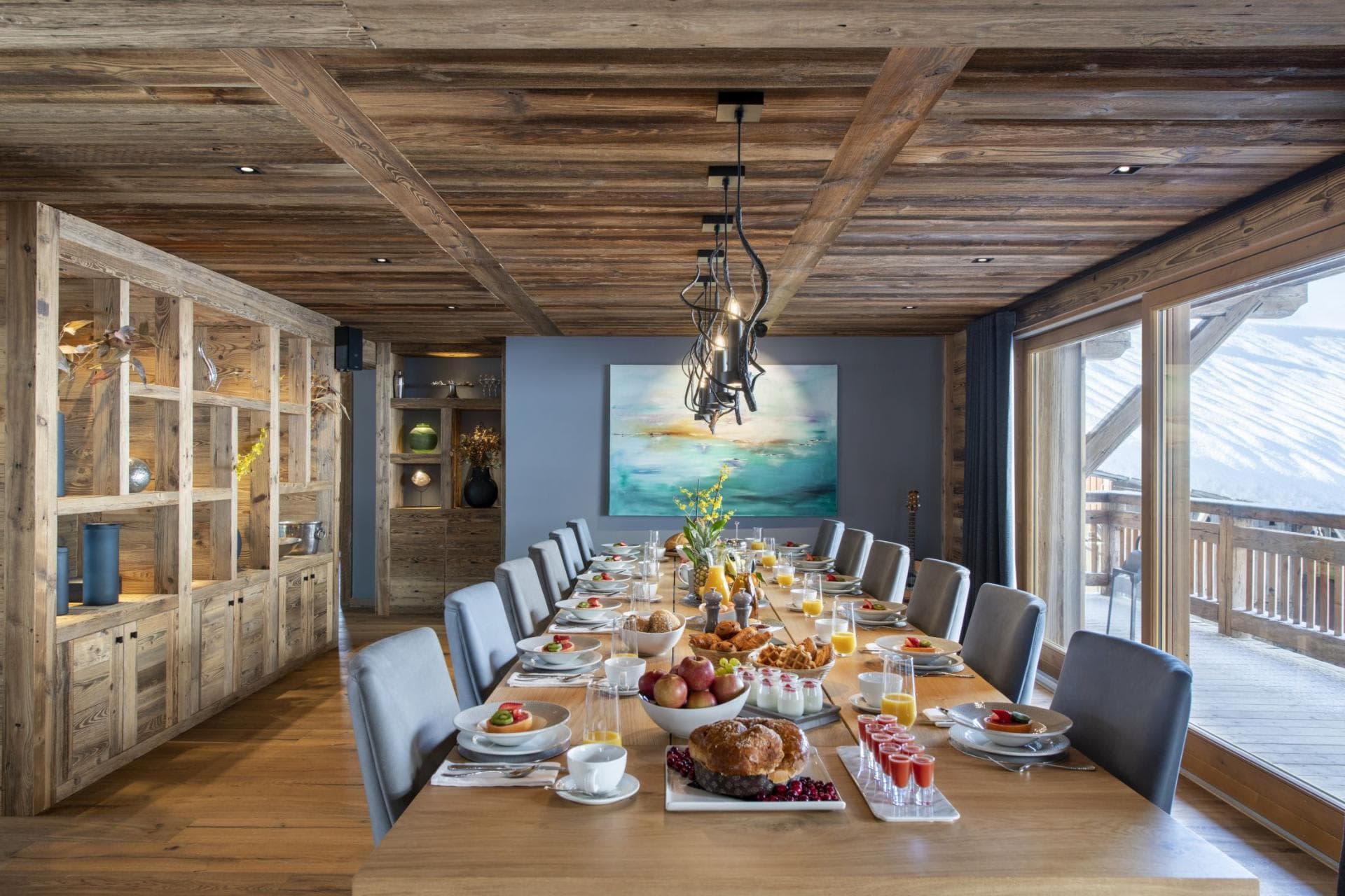 Dining area seats 12 with terrace access and mountain views