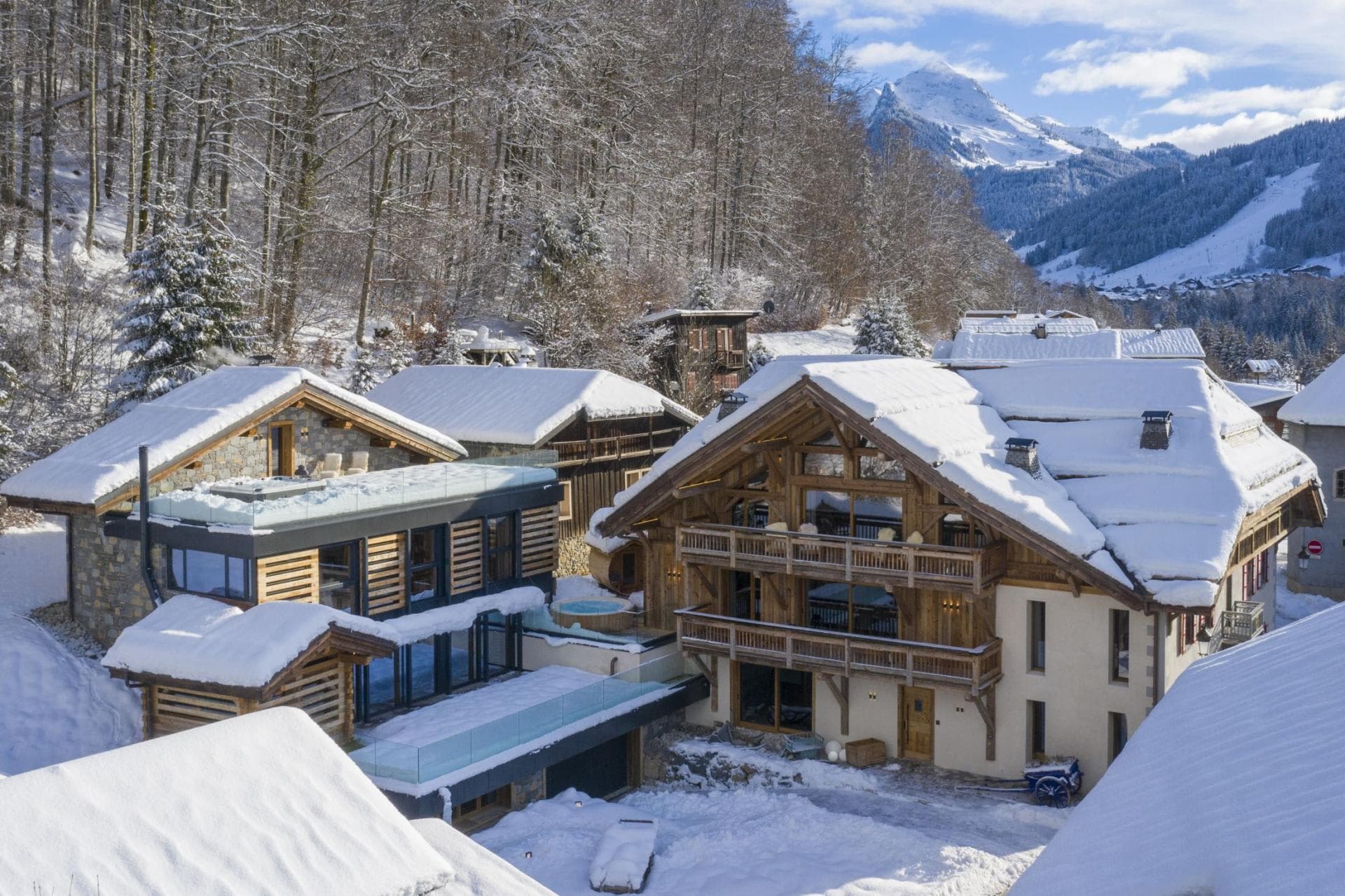 Chalet exterior featuring private hot tub and mountain views
