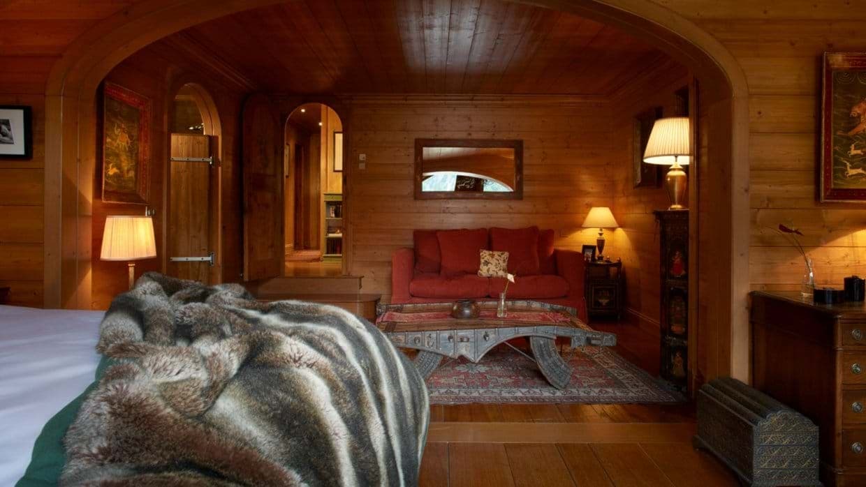 Primary suite with wood-paneled sitting area and private hallway access