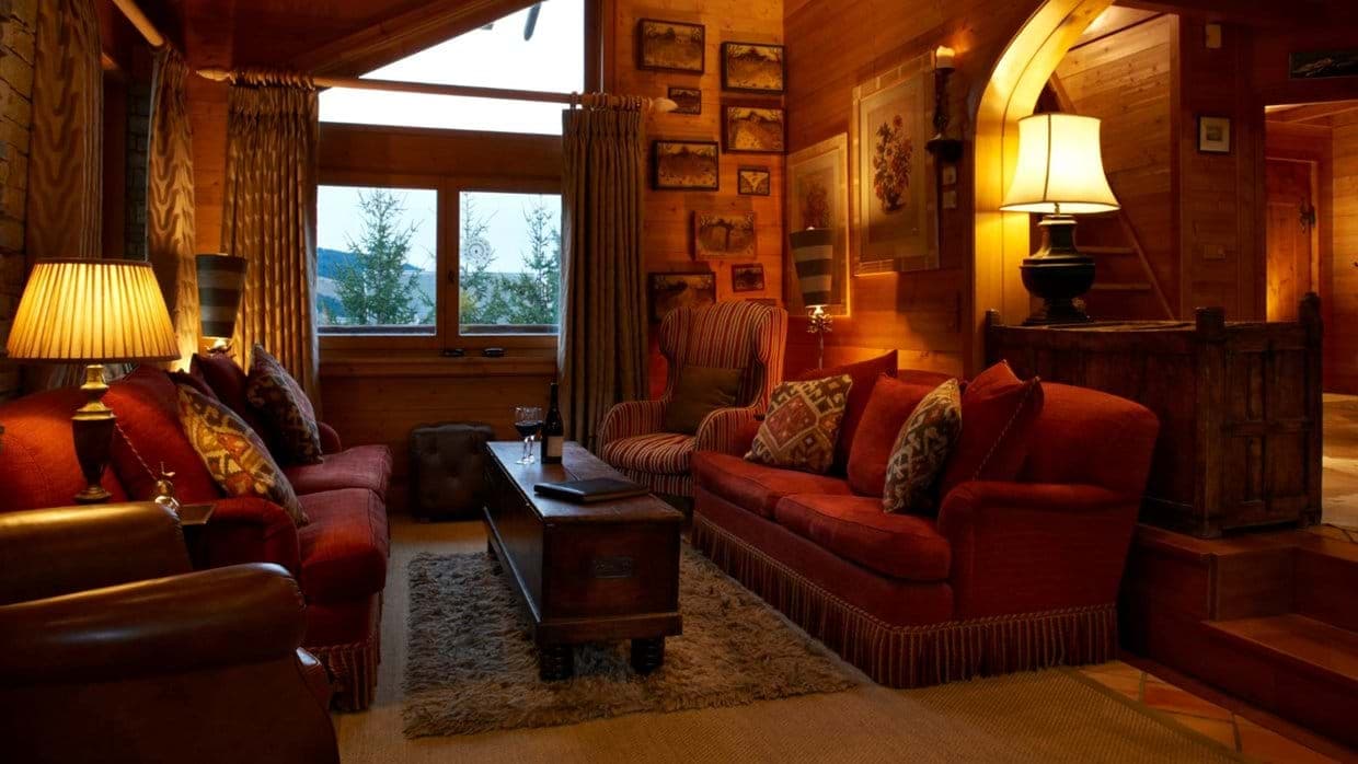 Wood-paneled living room with sofa seating for five and mountain views