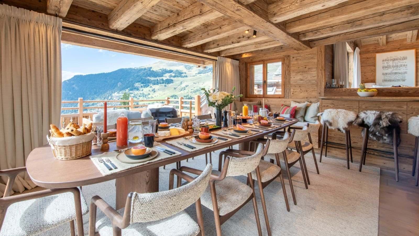 Dining table seats 10 with mountain views and balcony access