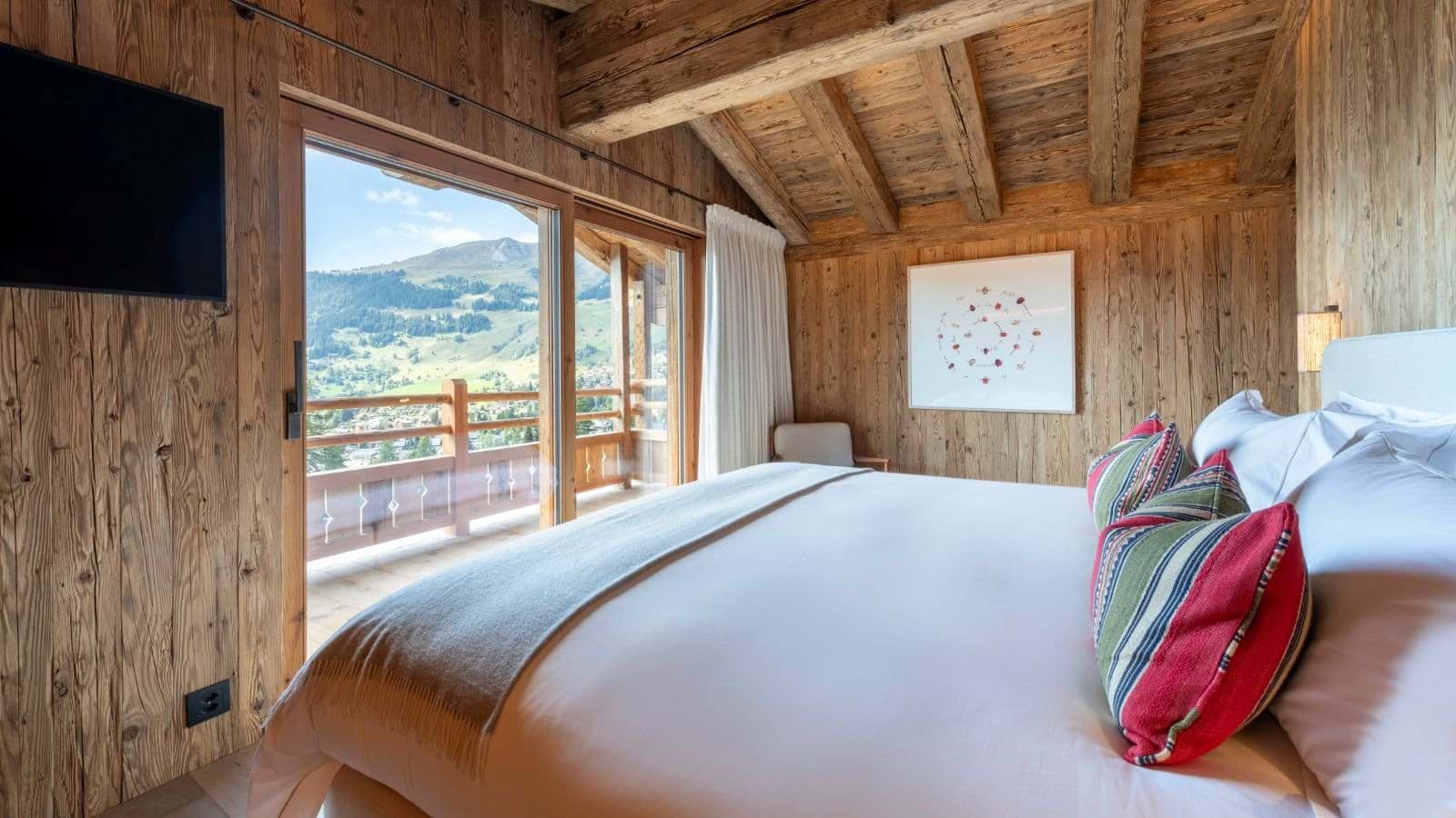 Bedroom with king bed and balcony access mountain views