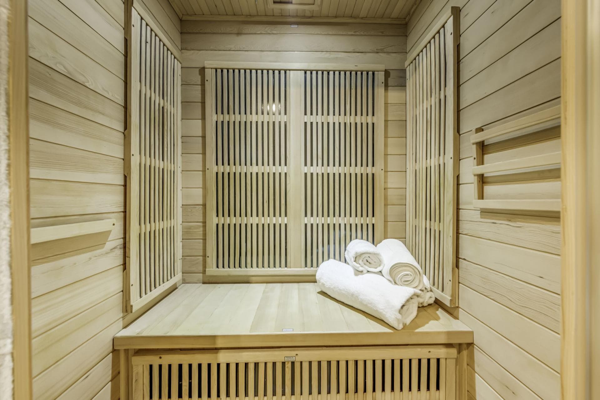 Private infrared sauna with cedar wood paneling and integrated heating elements