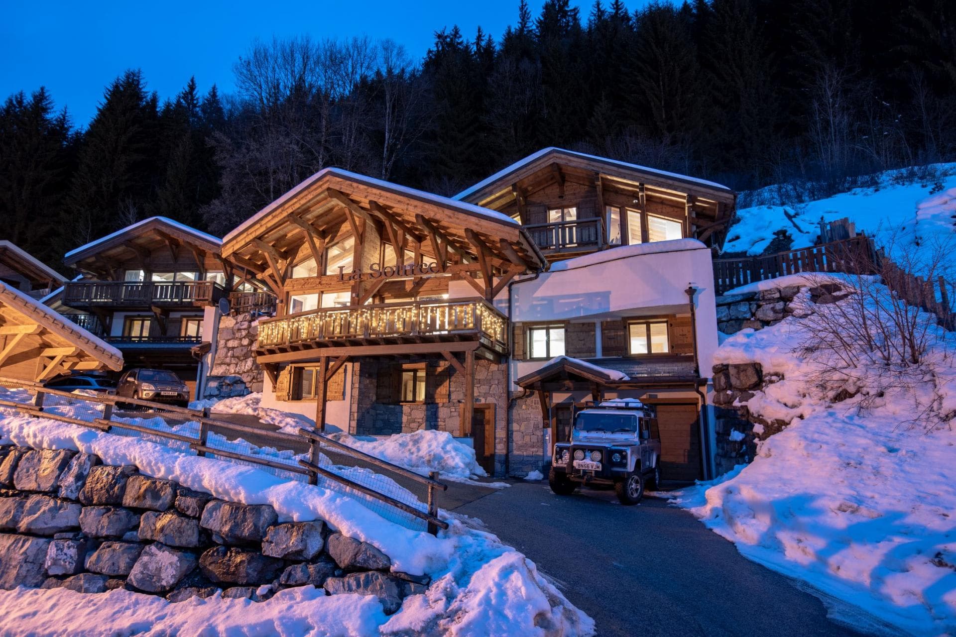 Chalet exterior with driveway parking and private garage access