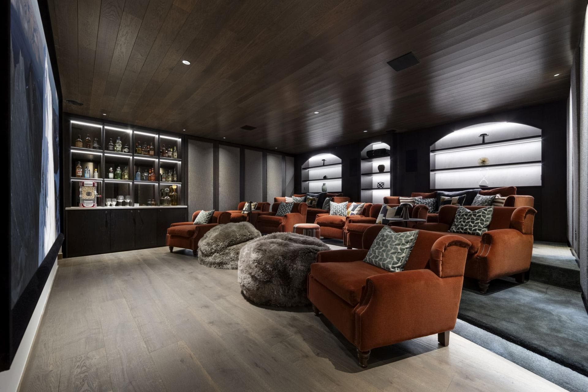 Private cinema with tiered seating for 10 and built-in wet bar