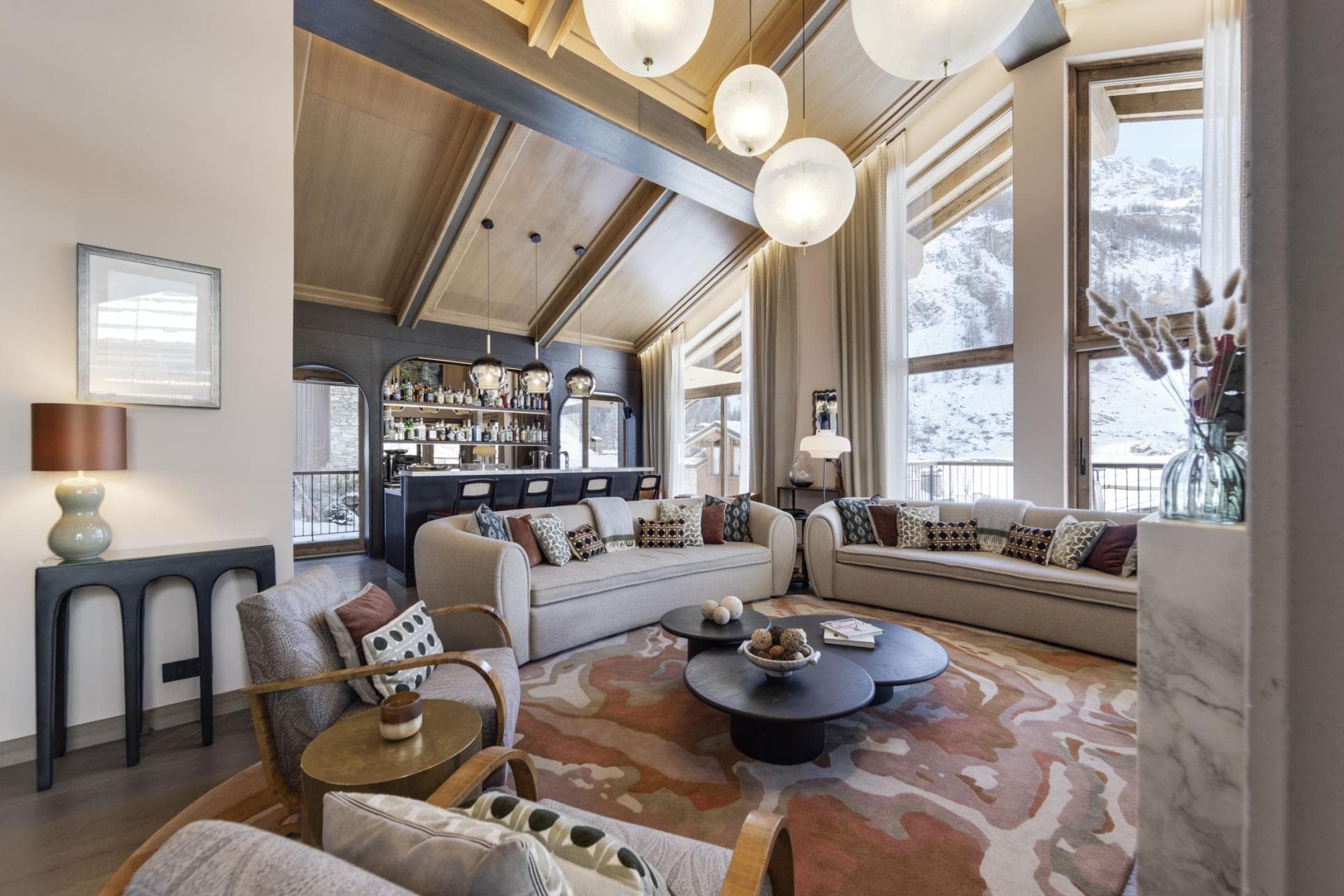 Open living area with full bar and floor-to-ceiling mountain views