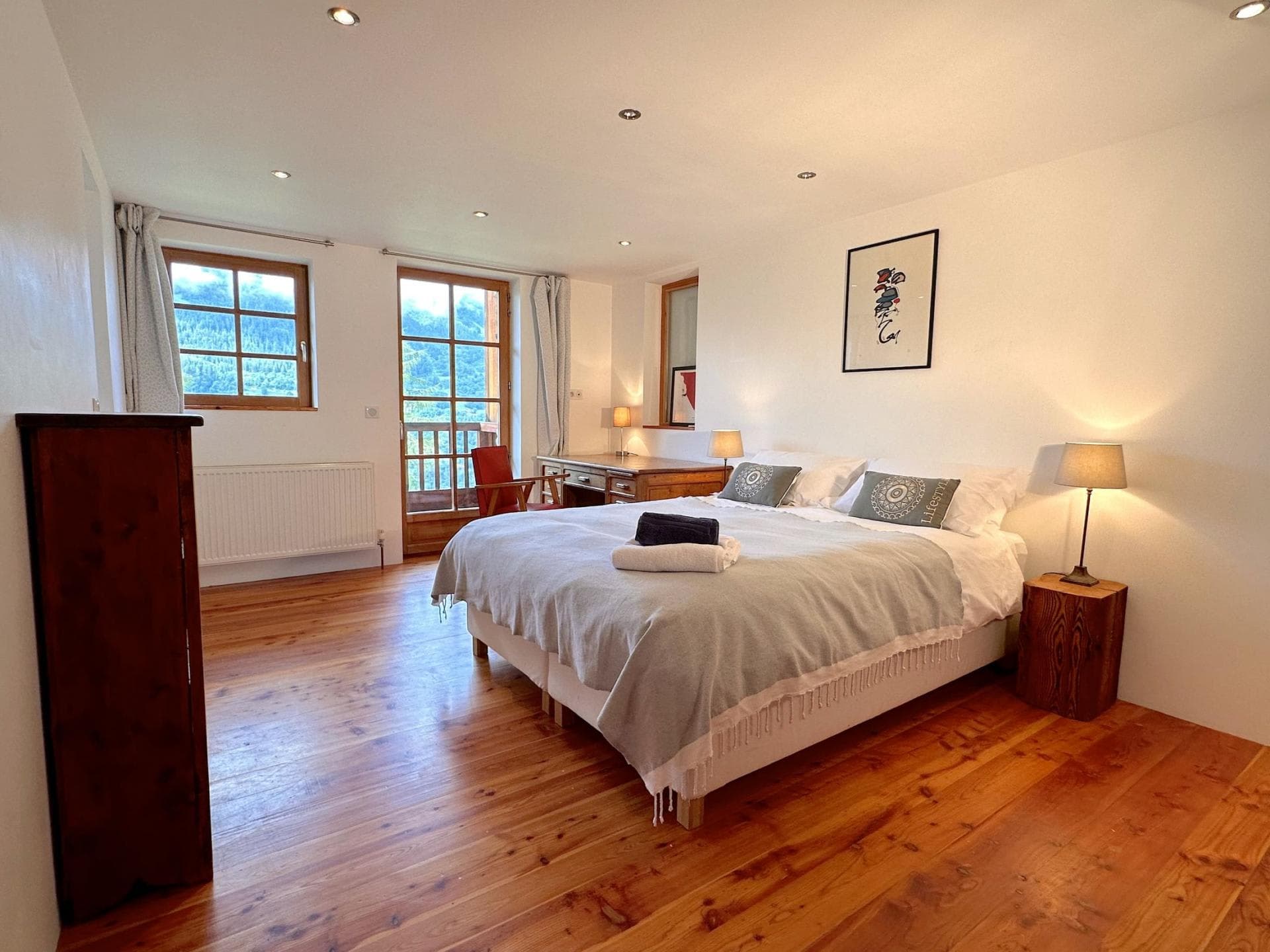 Bedroom with king bed, hardwood floors, and balcony access