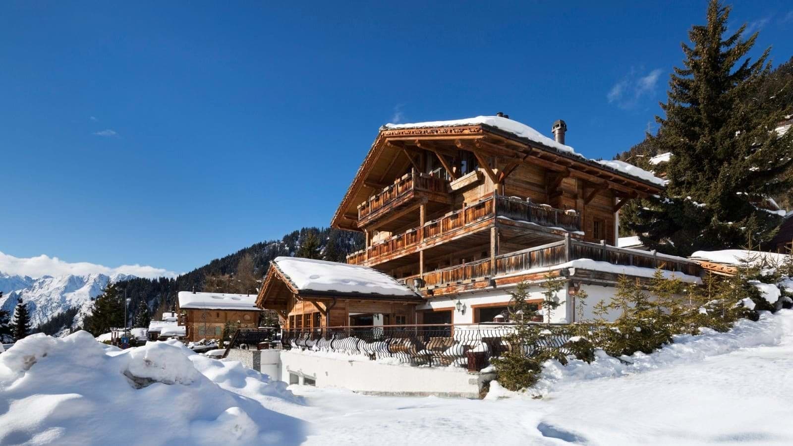 Chalet exterior with multi-level wrap-around balconies and mountain views