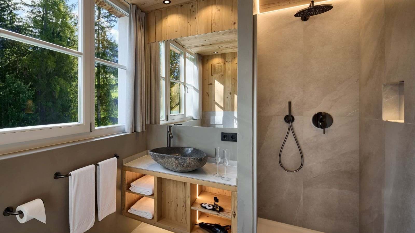 Bathroom featuring stone vessel sink and walk-in rain shower