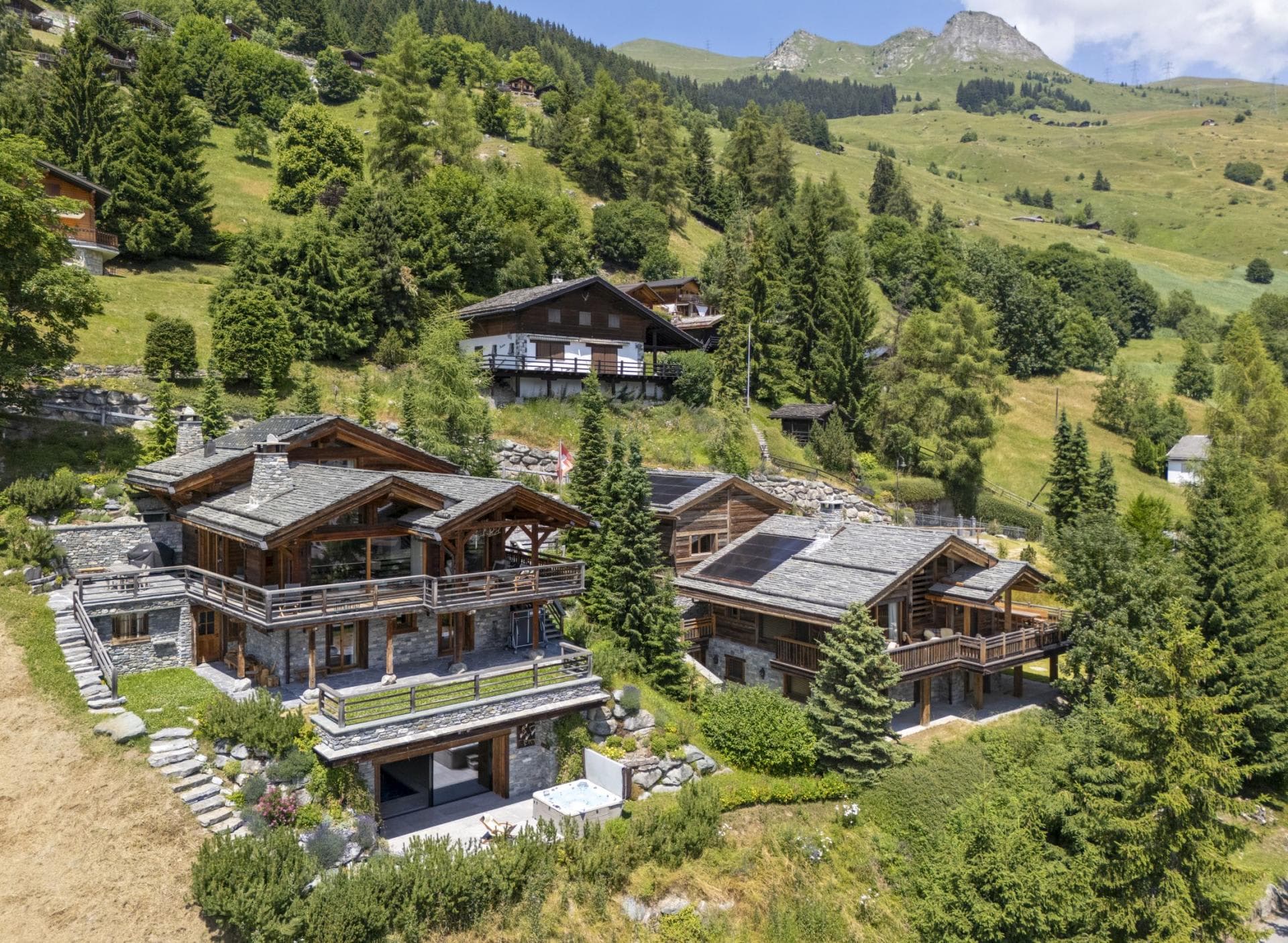 Stone and timber chalets with hot tub and alpine mountain views