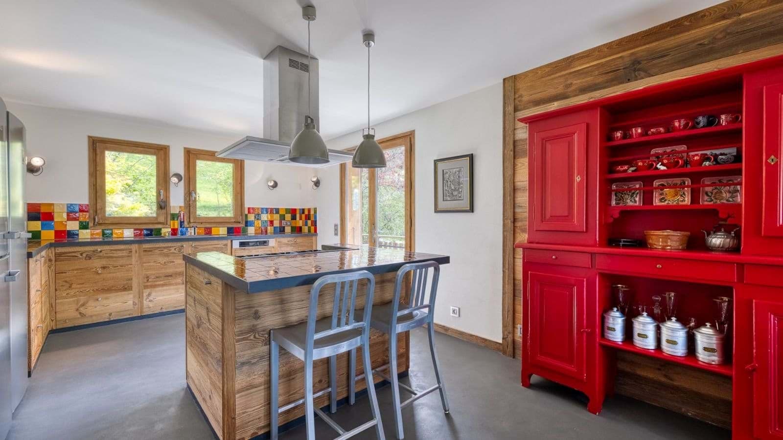 Kitchen with tiled island, induction cooktop, and red hutch storage