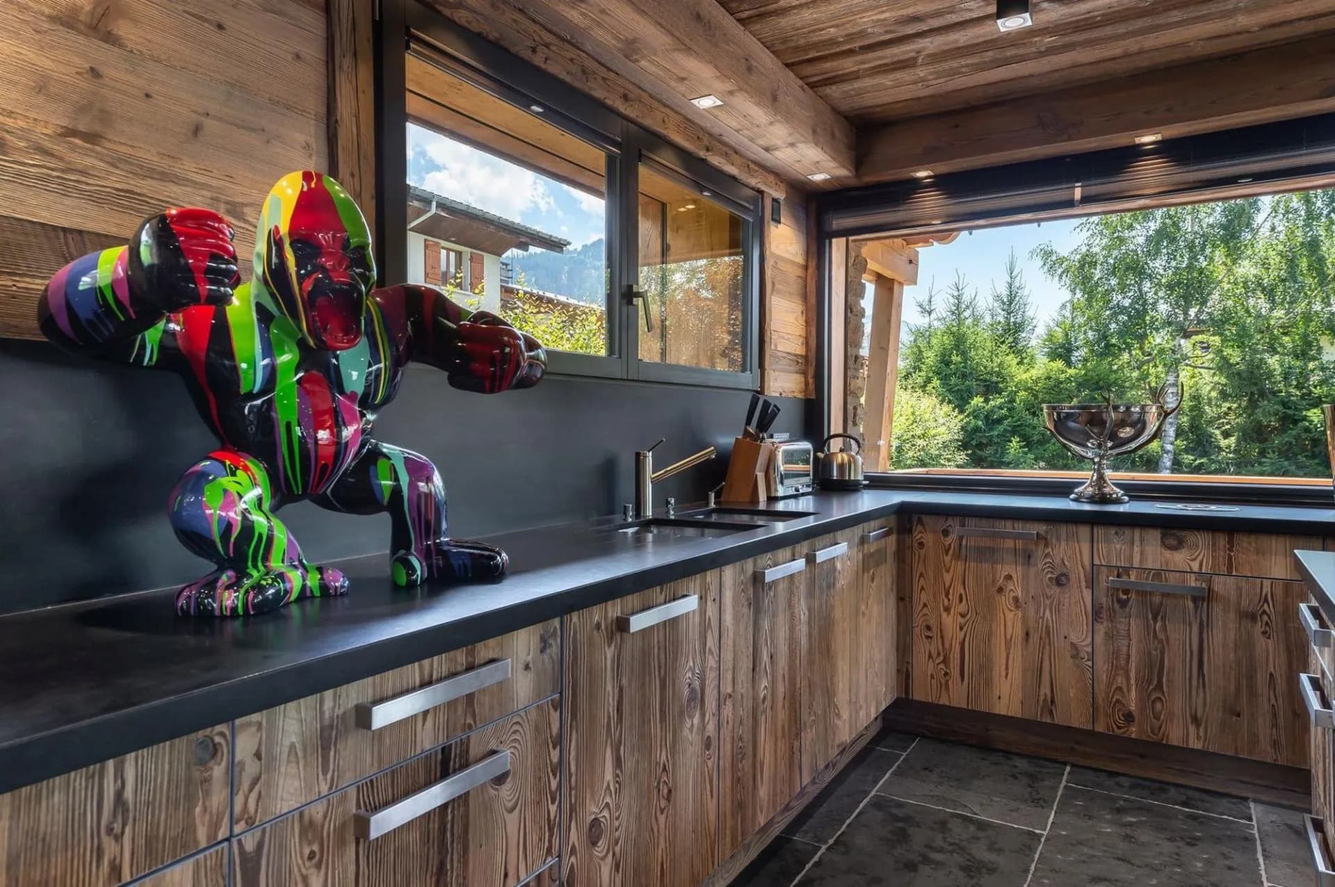 Fitted kitchen with colourful decorative artwork