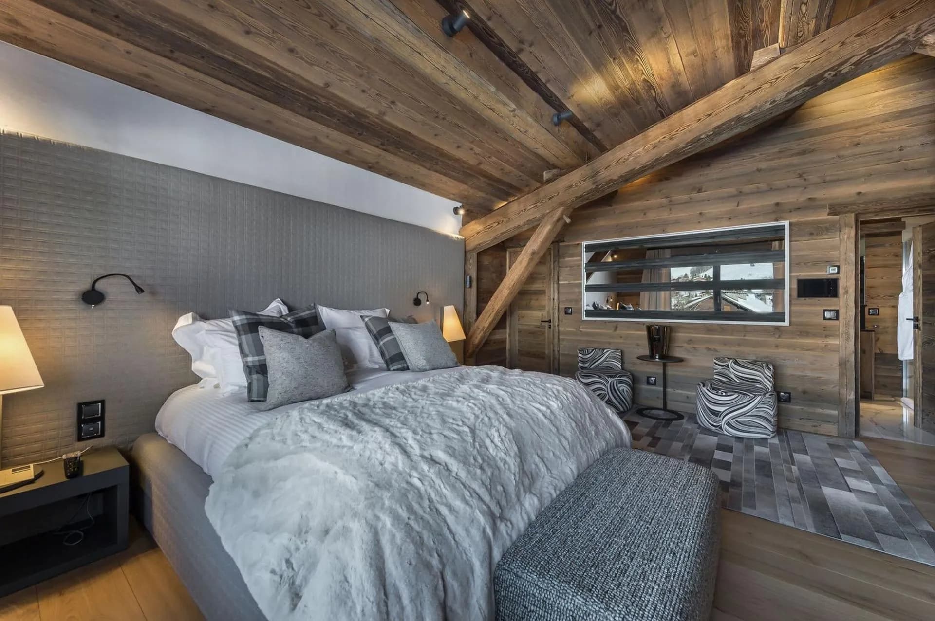 Double bedroom with timber walls and skylight
