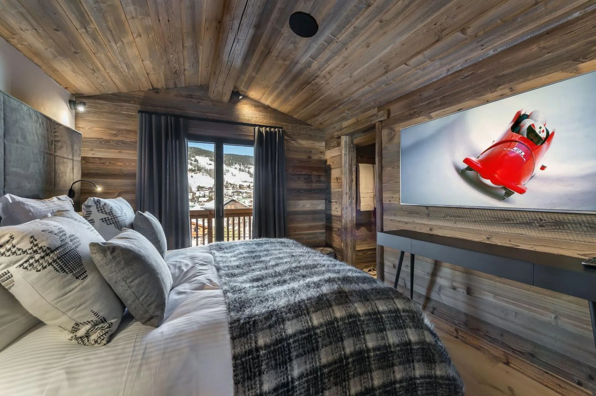 Double bedroom with timber walls and terrace doors
