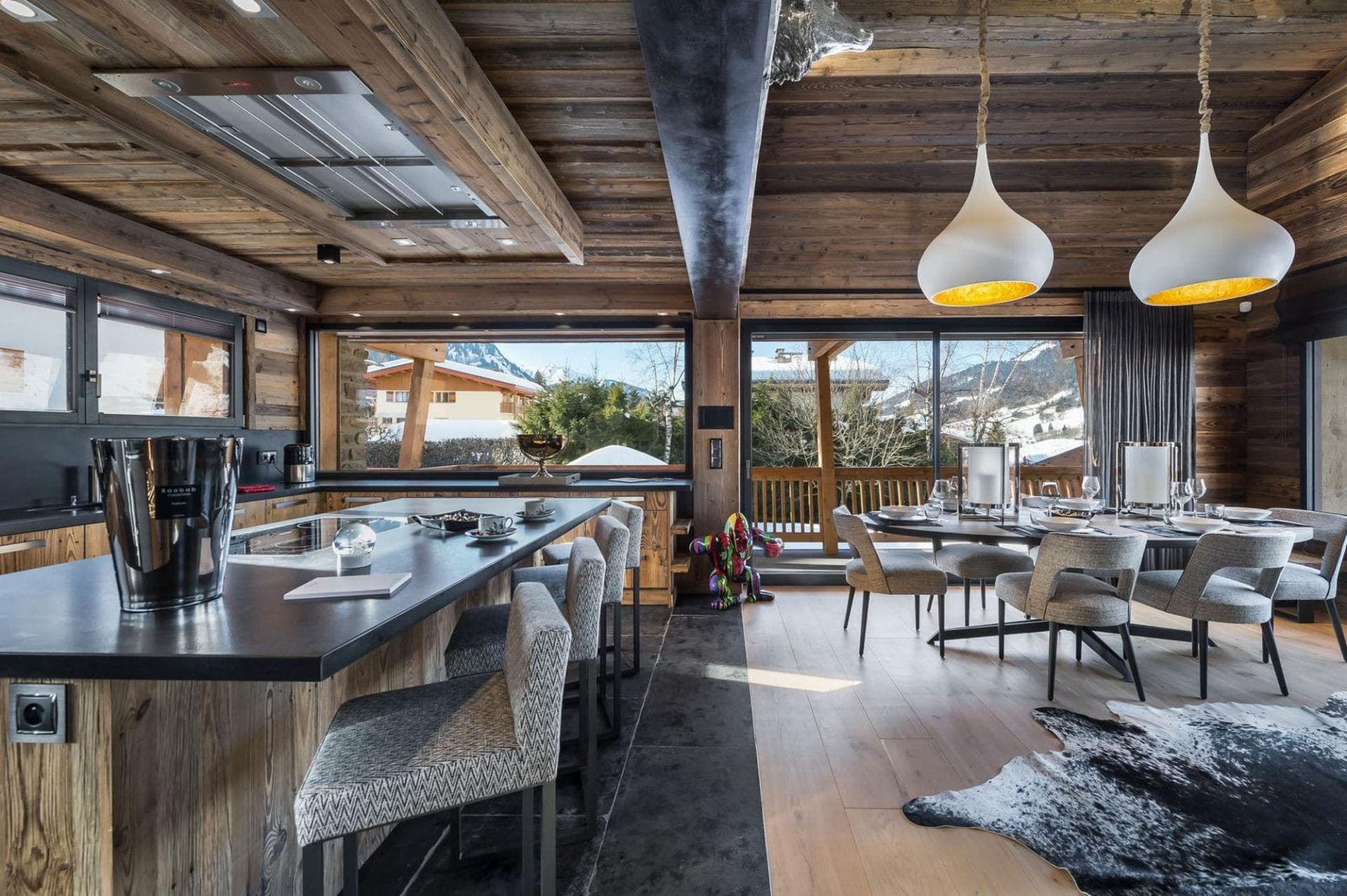 Open-plan kitchen and dining area with mountain views and terrace access