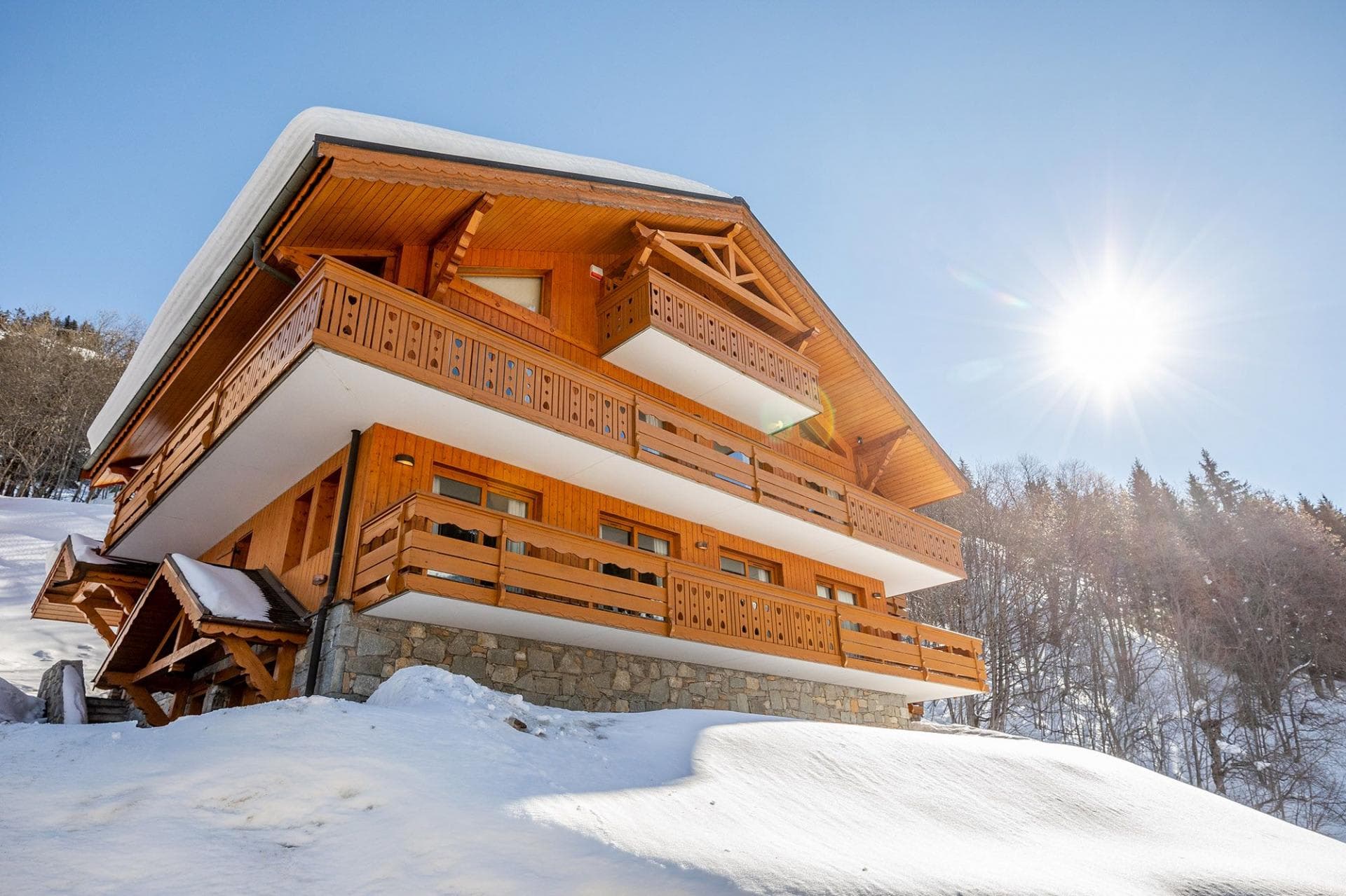 Ski-in/ski-out timber chalet with wrap-around balconies and south-facing exposure