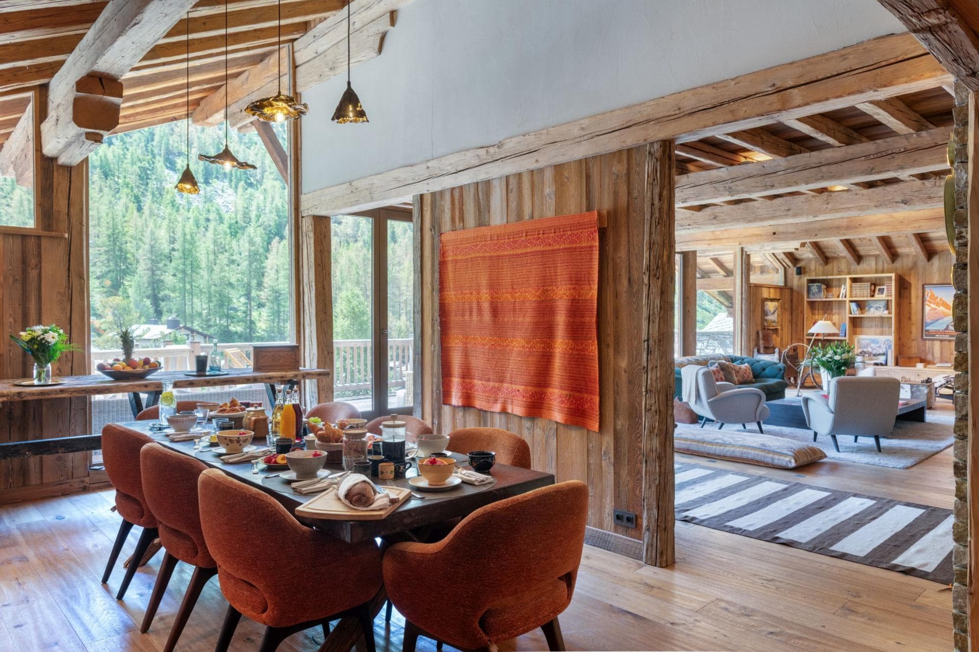 Dining area seats 8 with vaulted ceilings and forest views