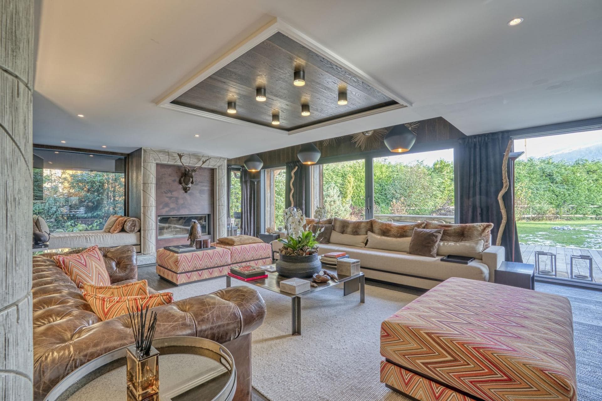 Living area with wood-burning fireplace and sliding door access to garden