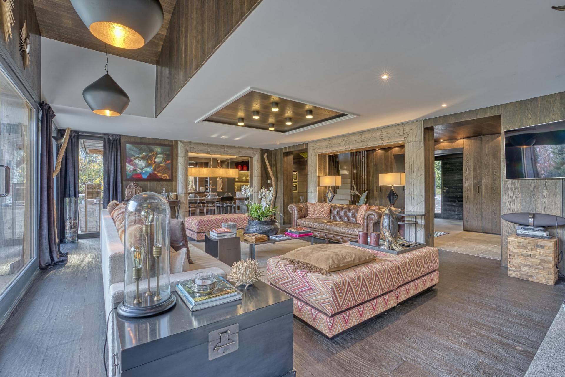 Open living area with leather chesterfield sofa and dining room access