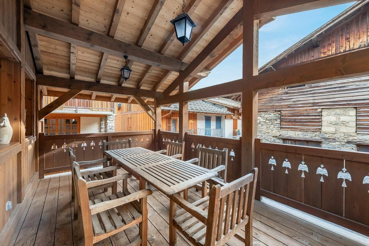 Covered balcony with dining seating for 6 and village views