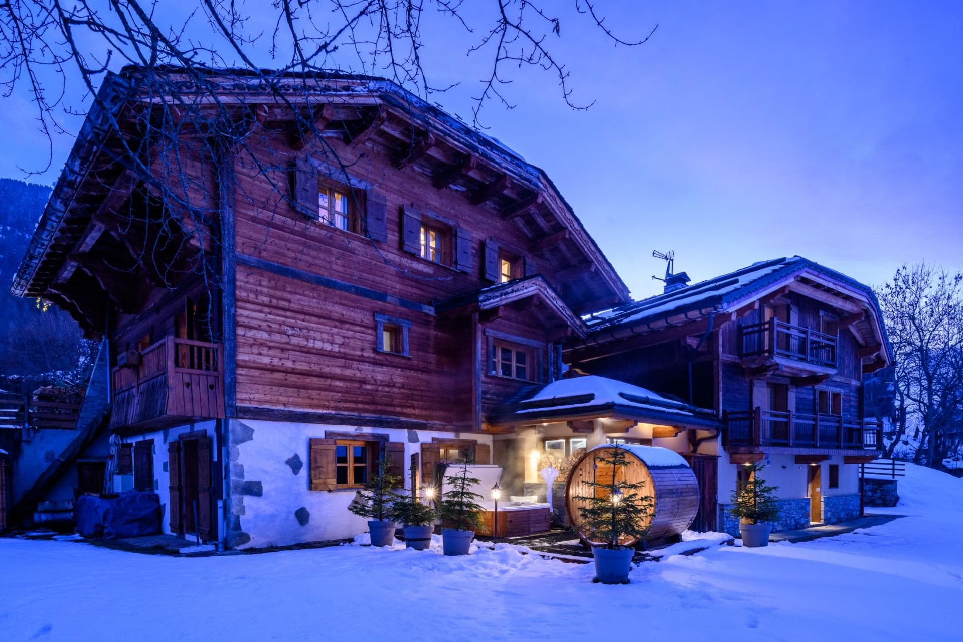 Chalet exterior featuring outdoor barrel sauna and heated hot tub