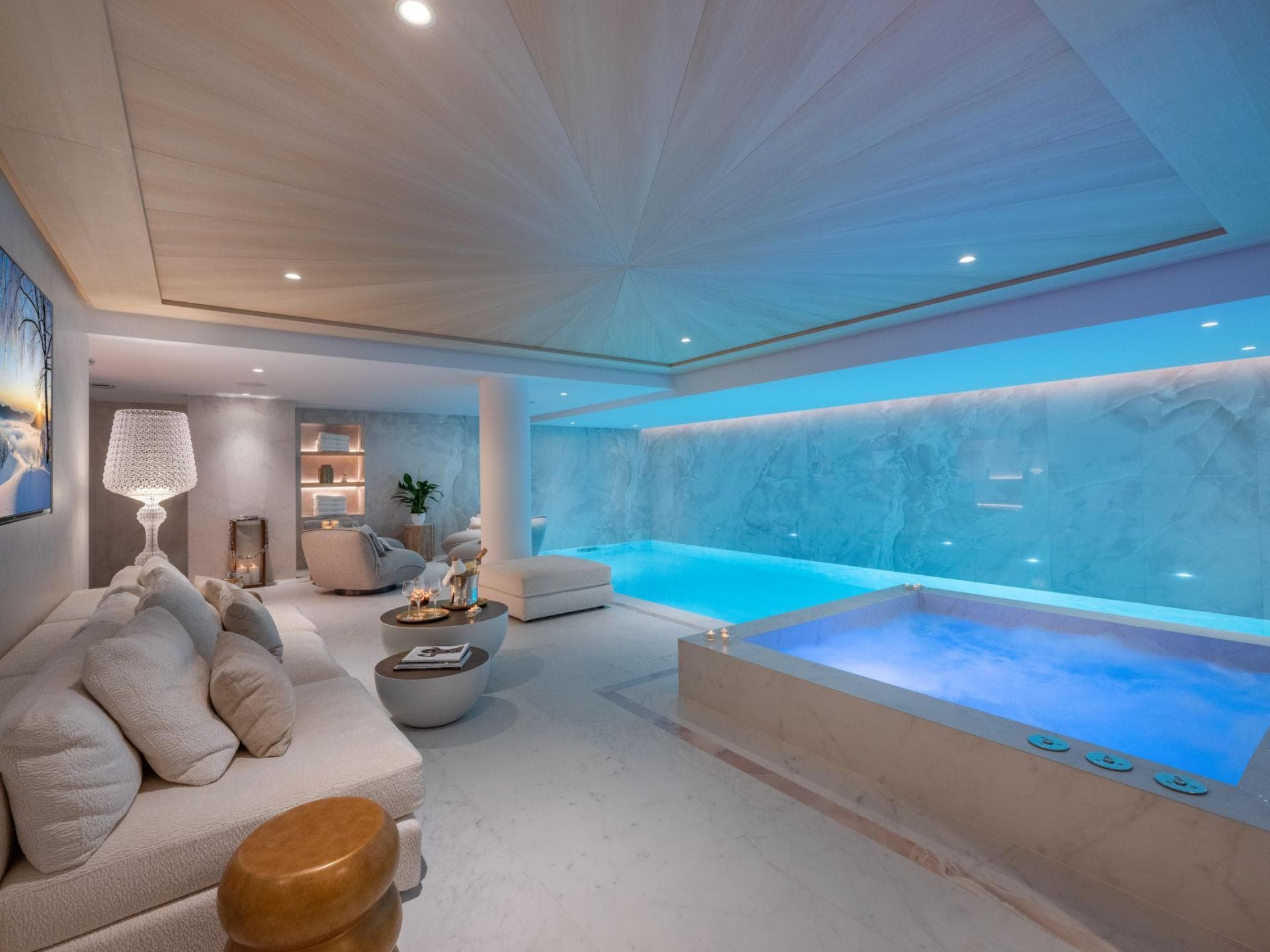 Indoor spa area with heated pool, hot tub, and lounge seating