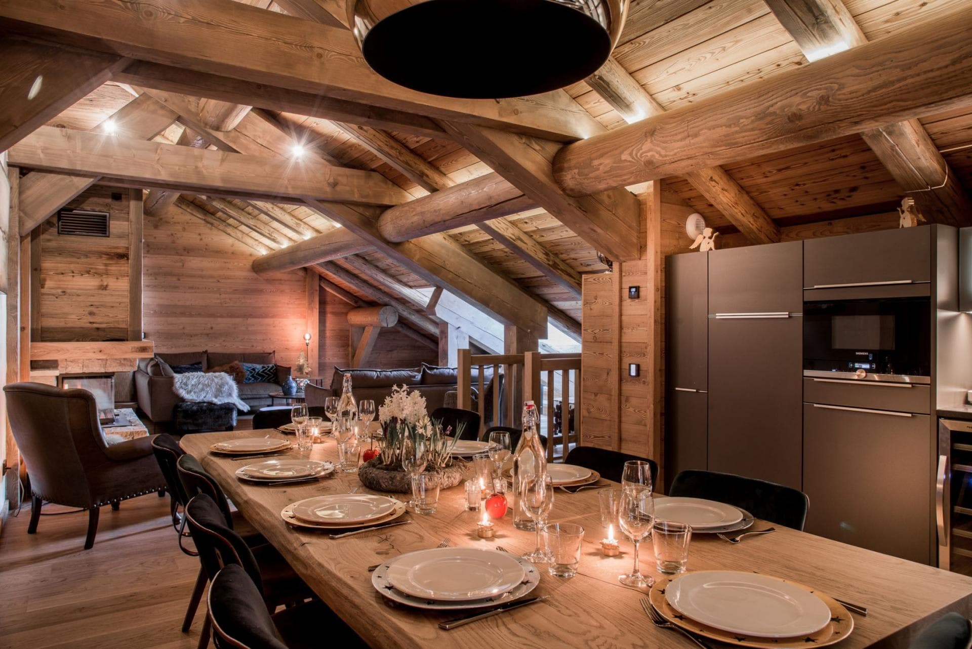 Open-plan dining area seats 10; living space with fireplace and exposed beams